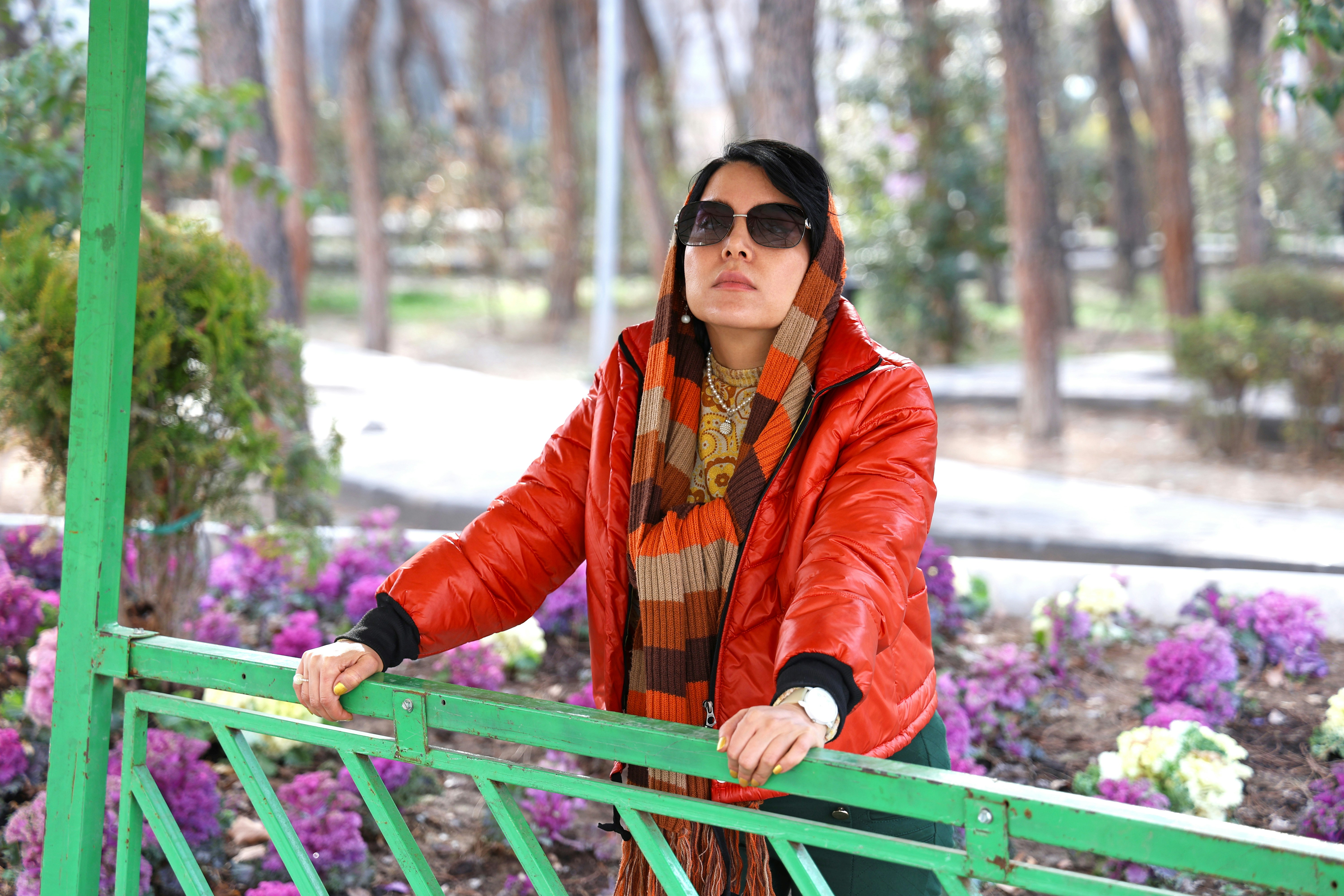 Woman in red jacket and scarf in park