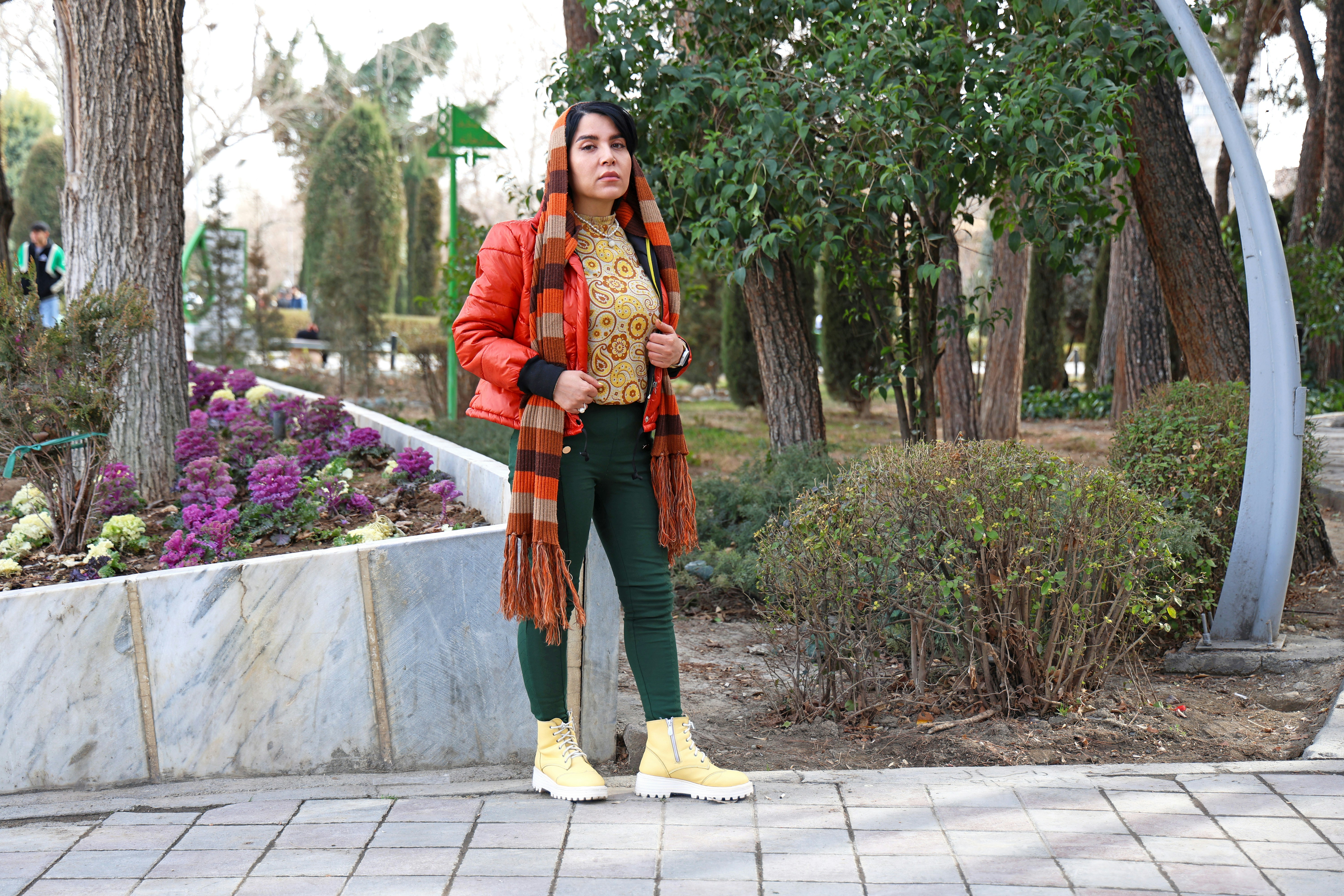 겨울철 남친룩·여친룩 스타일링 - Woman in orange jacket and scarf in park