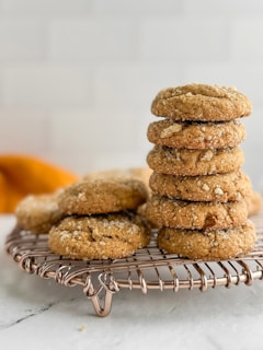 Stack of golden brown cookies on a cooling rack.
