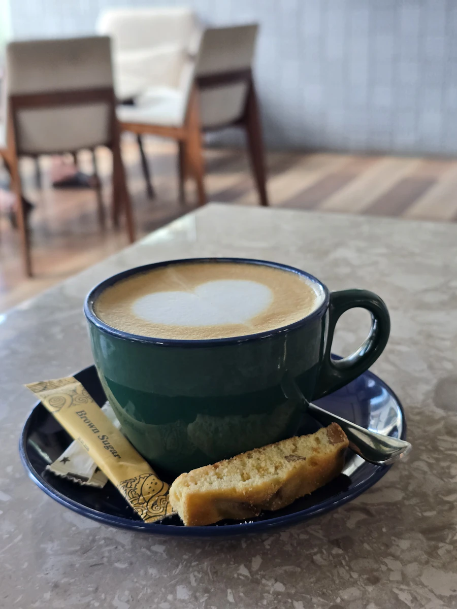 Latte art and biscotti served at Maple & Thistle Café