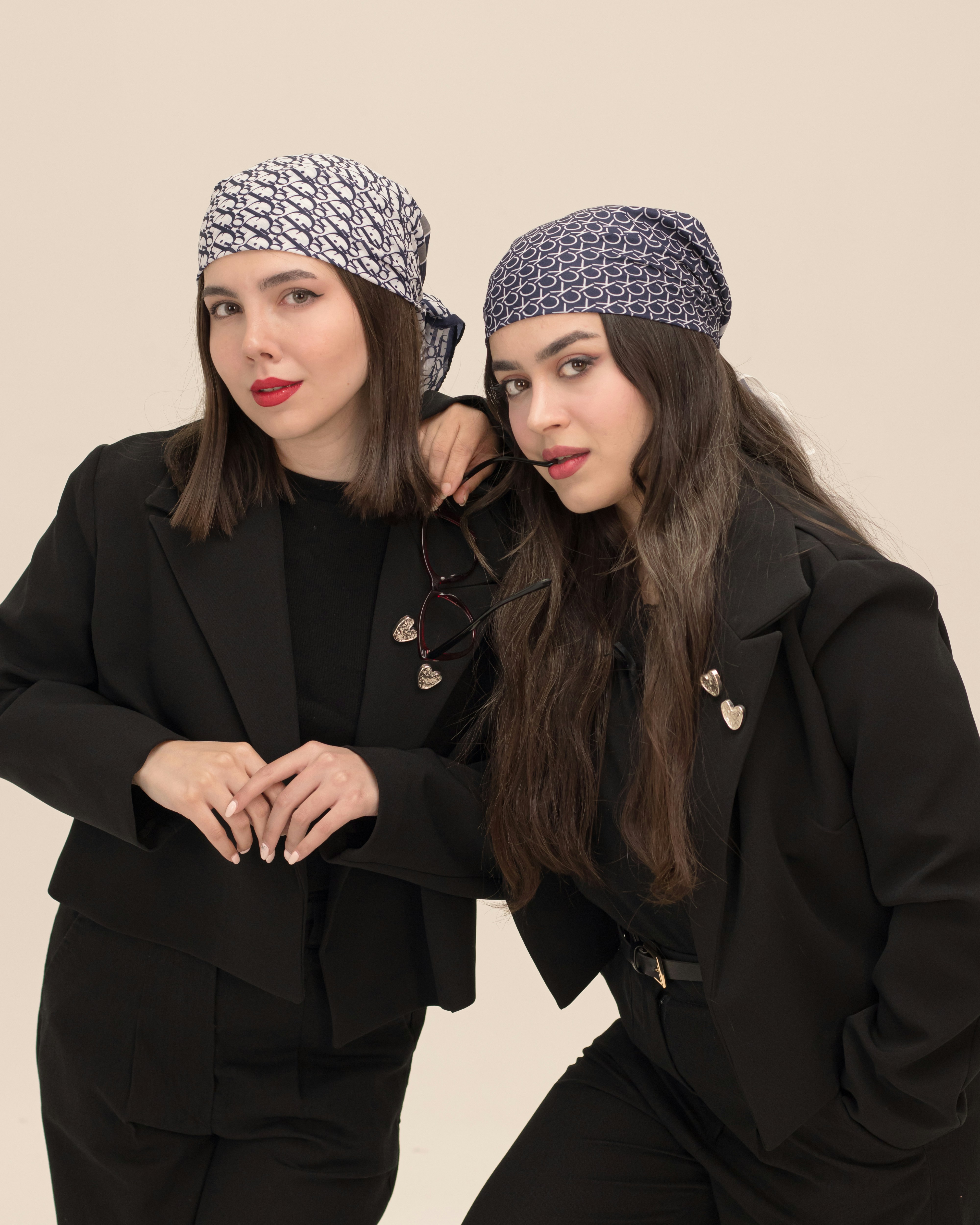 Two stylish women in bandanas and blazers