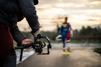 Filming a person with a camera gimbal outdoors.