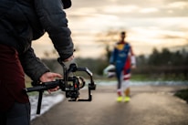 Filming a person with a camera gimbal outdoors.