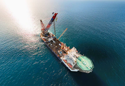 A large construction vessel with a crane at sea