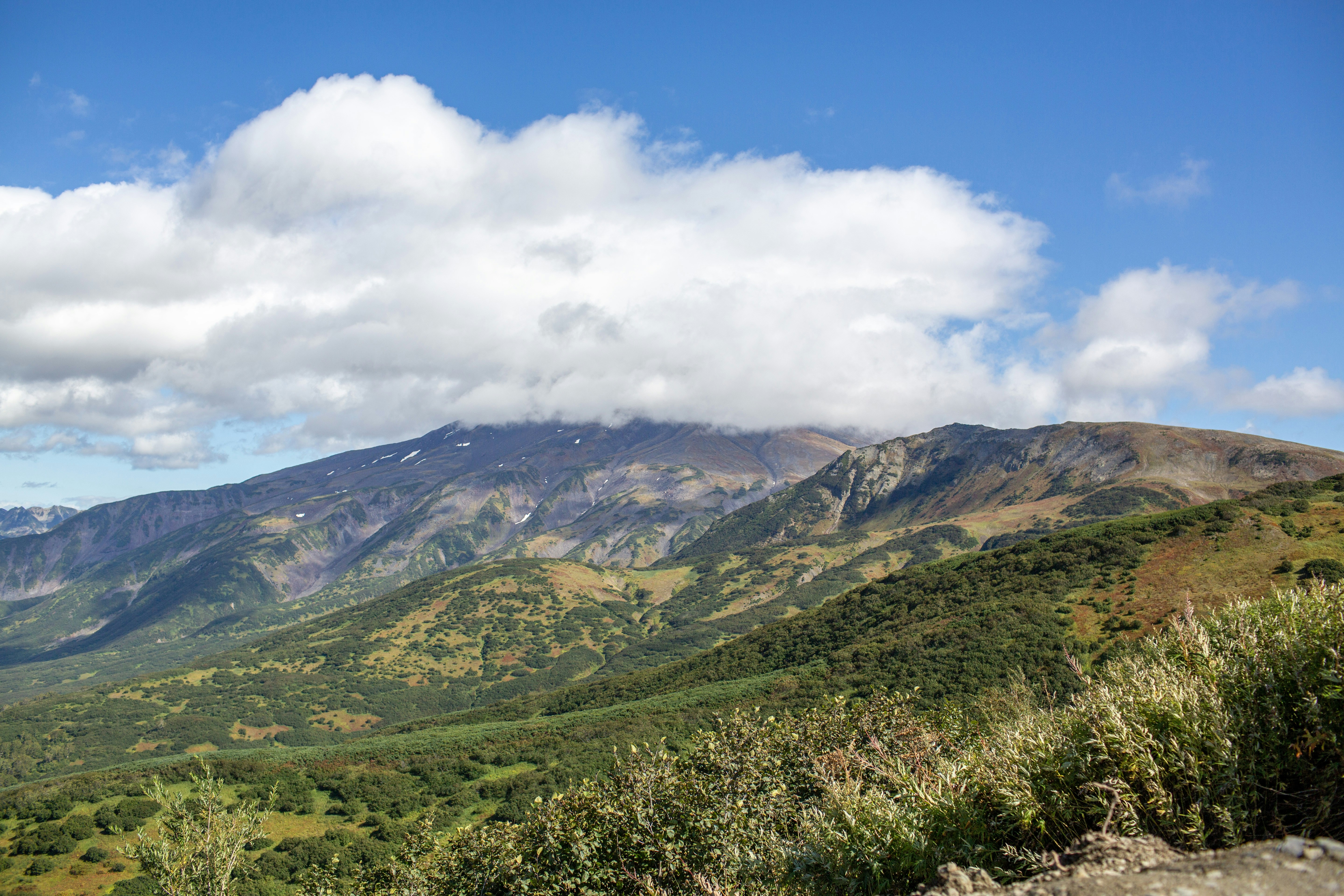 Majestic mountain range under a cloudy blue sky