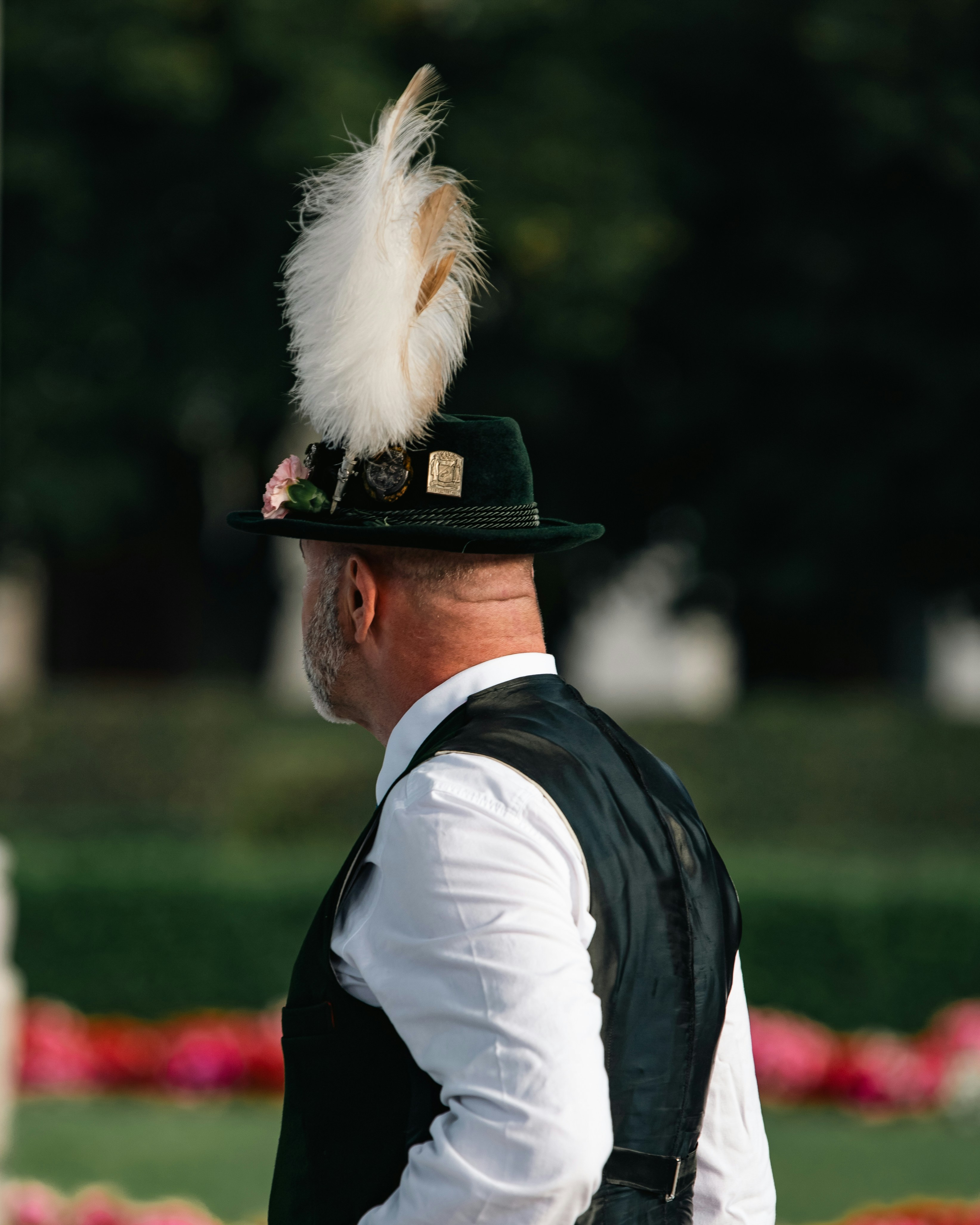 Man in traditional hat with feather outdoors
