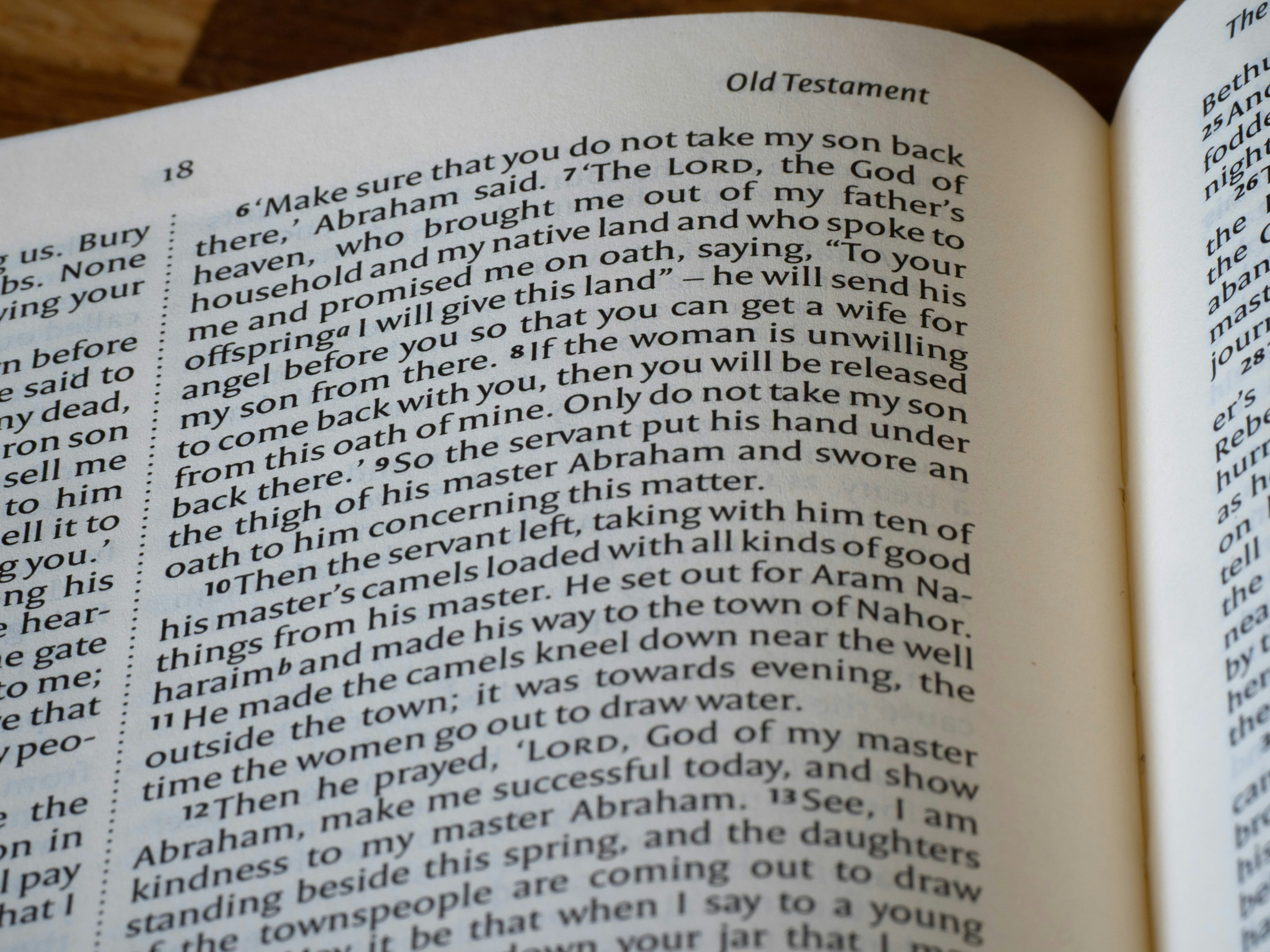 Close-up of an open bible showing old testament text.