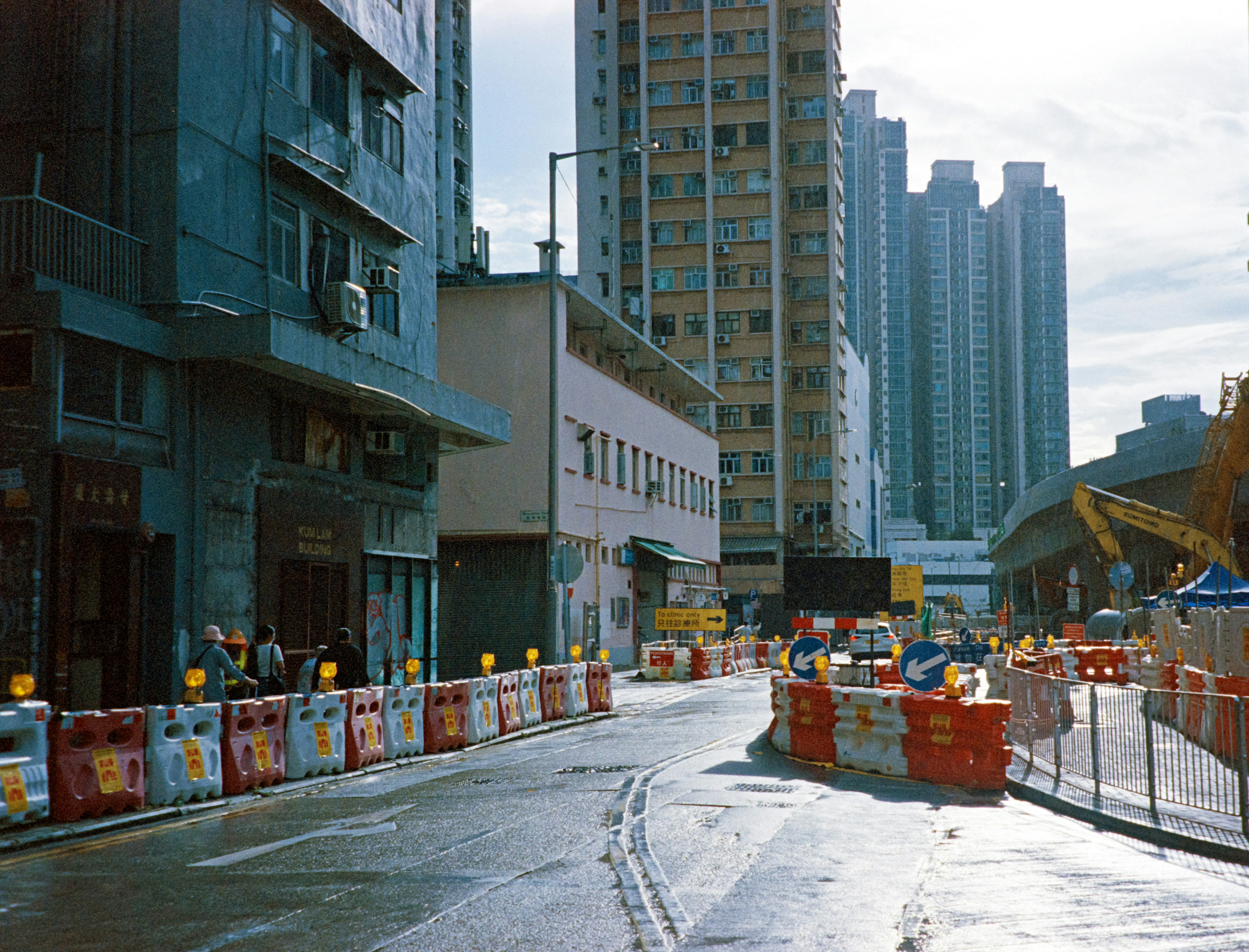 Tight urban construction site with heavy machinery and limited access - Construction equipment moving