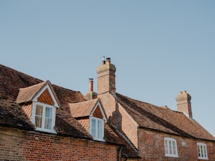 Brick houses with dormer windows under blue sky
