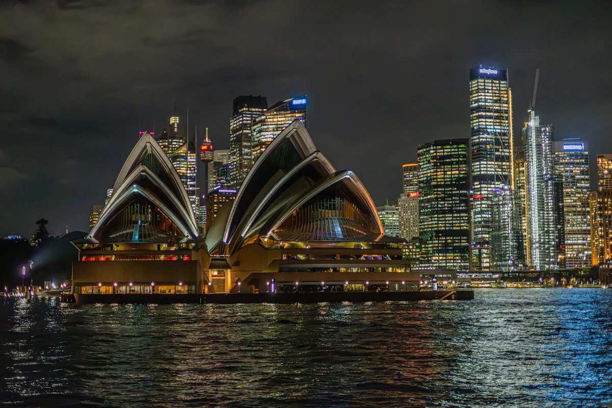Sydney Opera House and city skyline at night from across the harbour