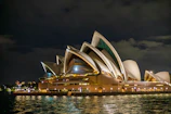 Sydney opera house at night with water reflections