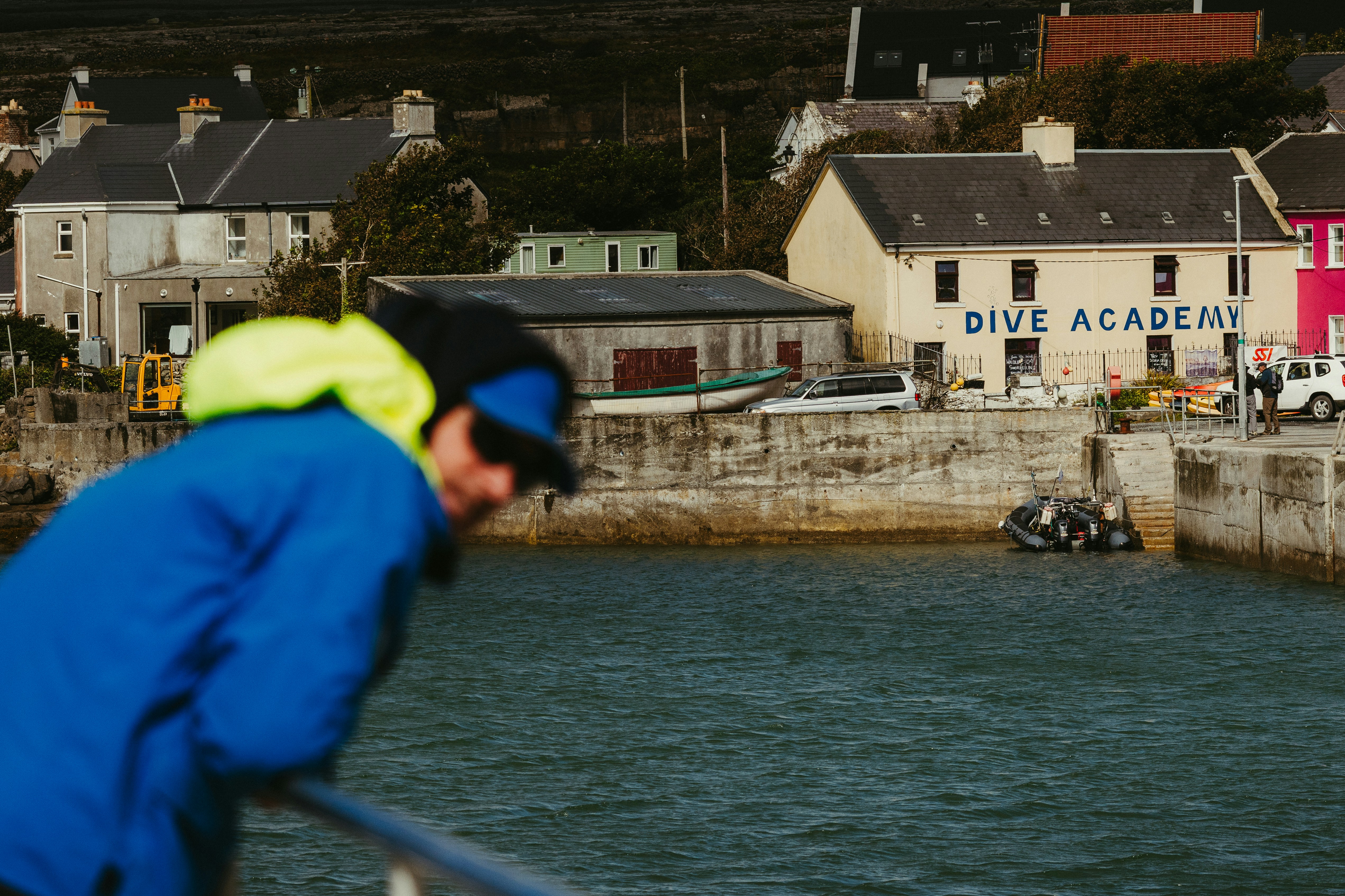 Diver looking out at a coastal town harbor