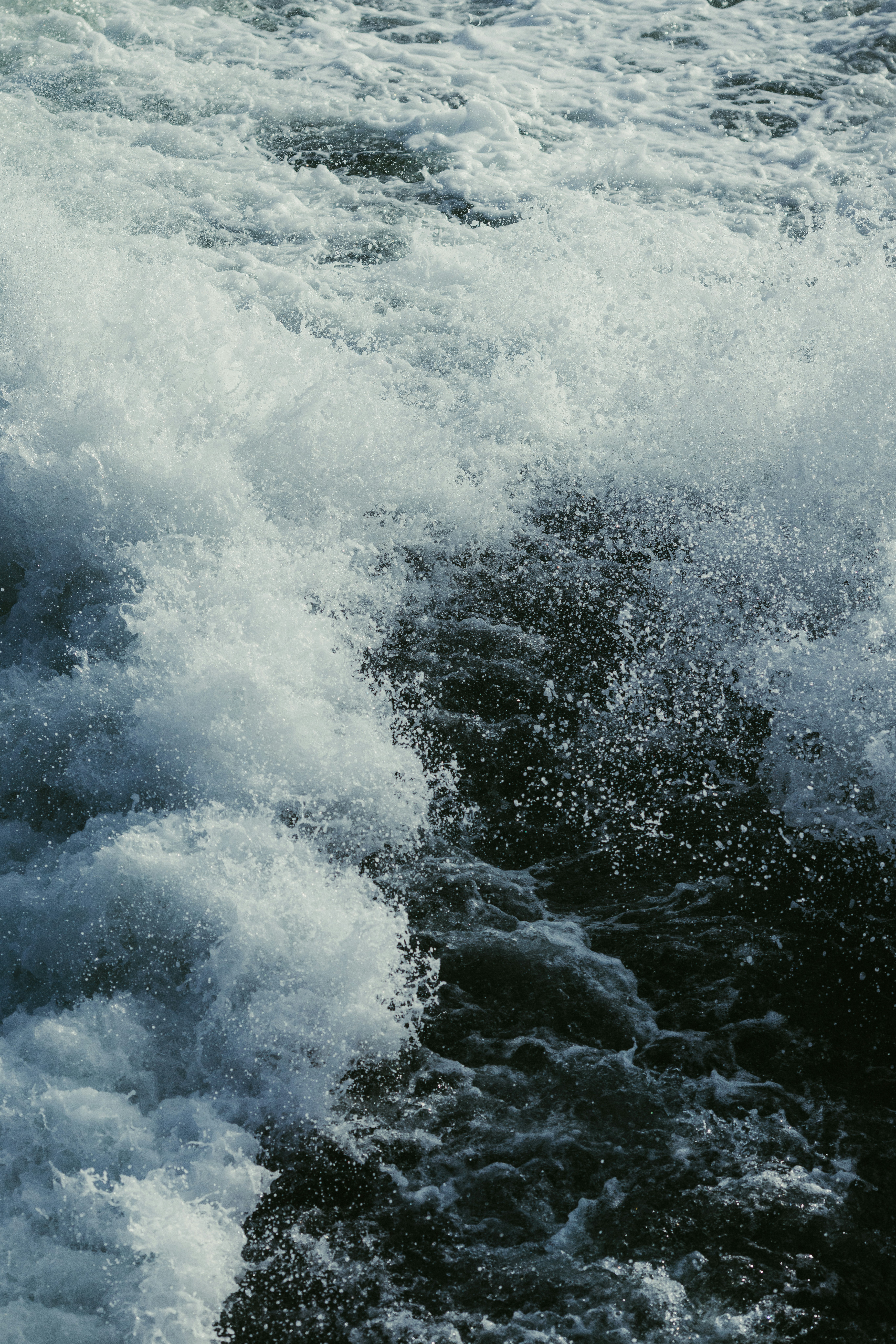 White water rapids crashing in dark water
