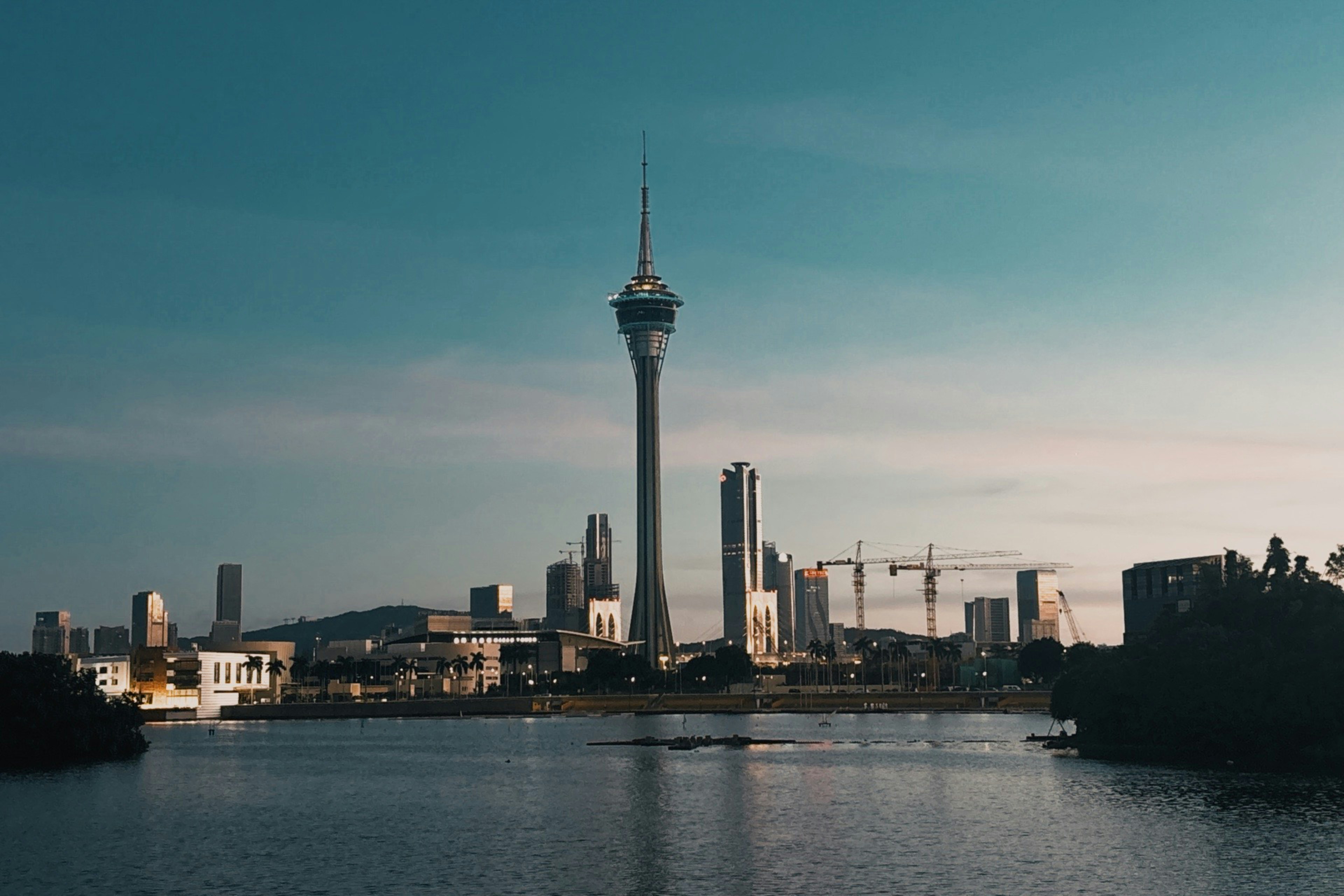 Modern cityscape with a tall observation tower and buildings.