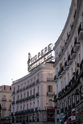 Tio pepe sign above curved buildings in madrid