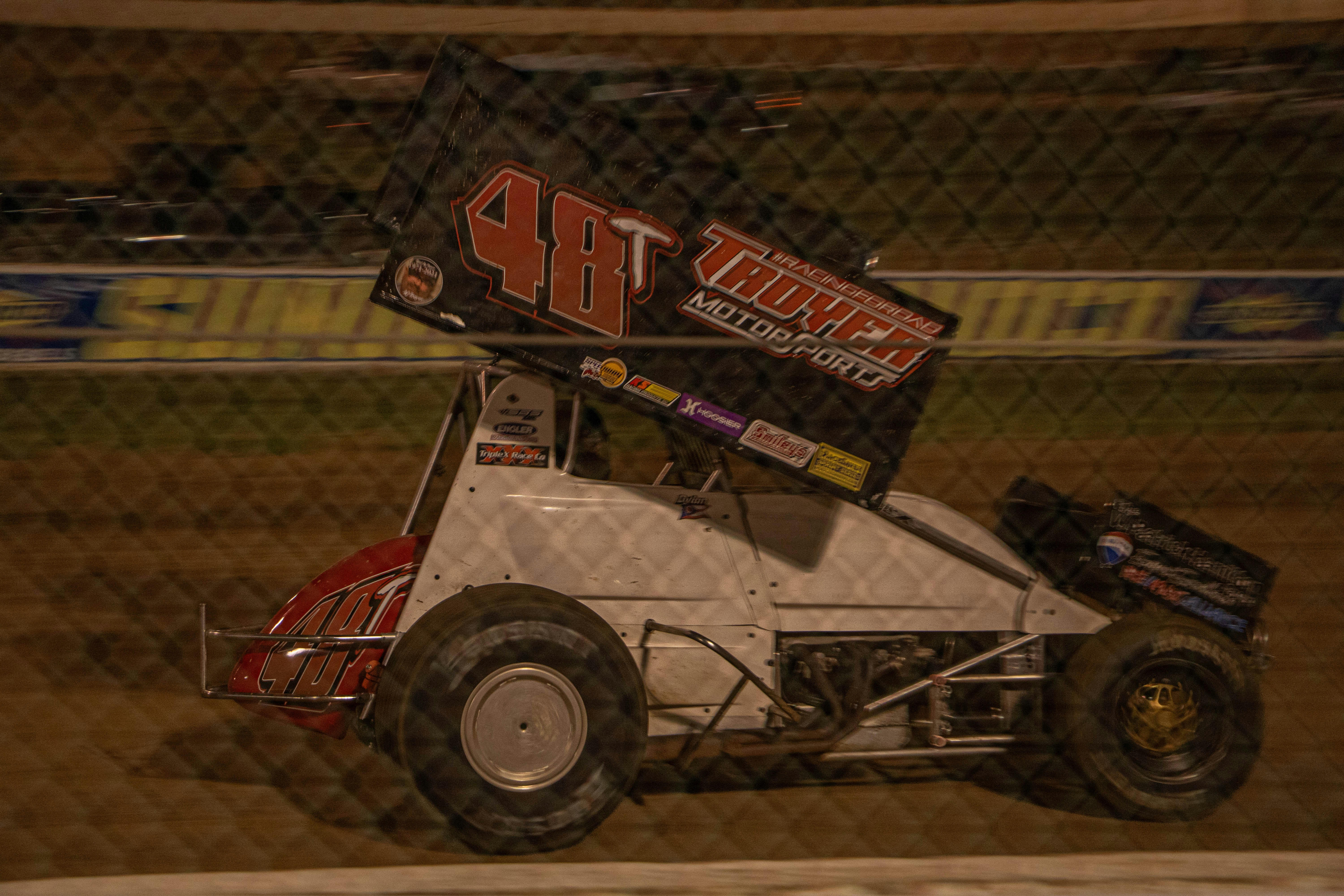 Sprint car racing on a dirt track at night