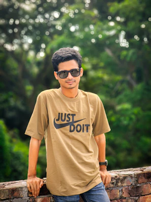 Young man in sunglasses and t-shirt outdoors