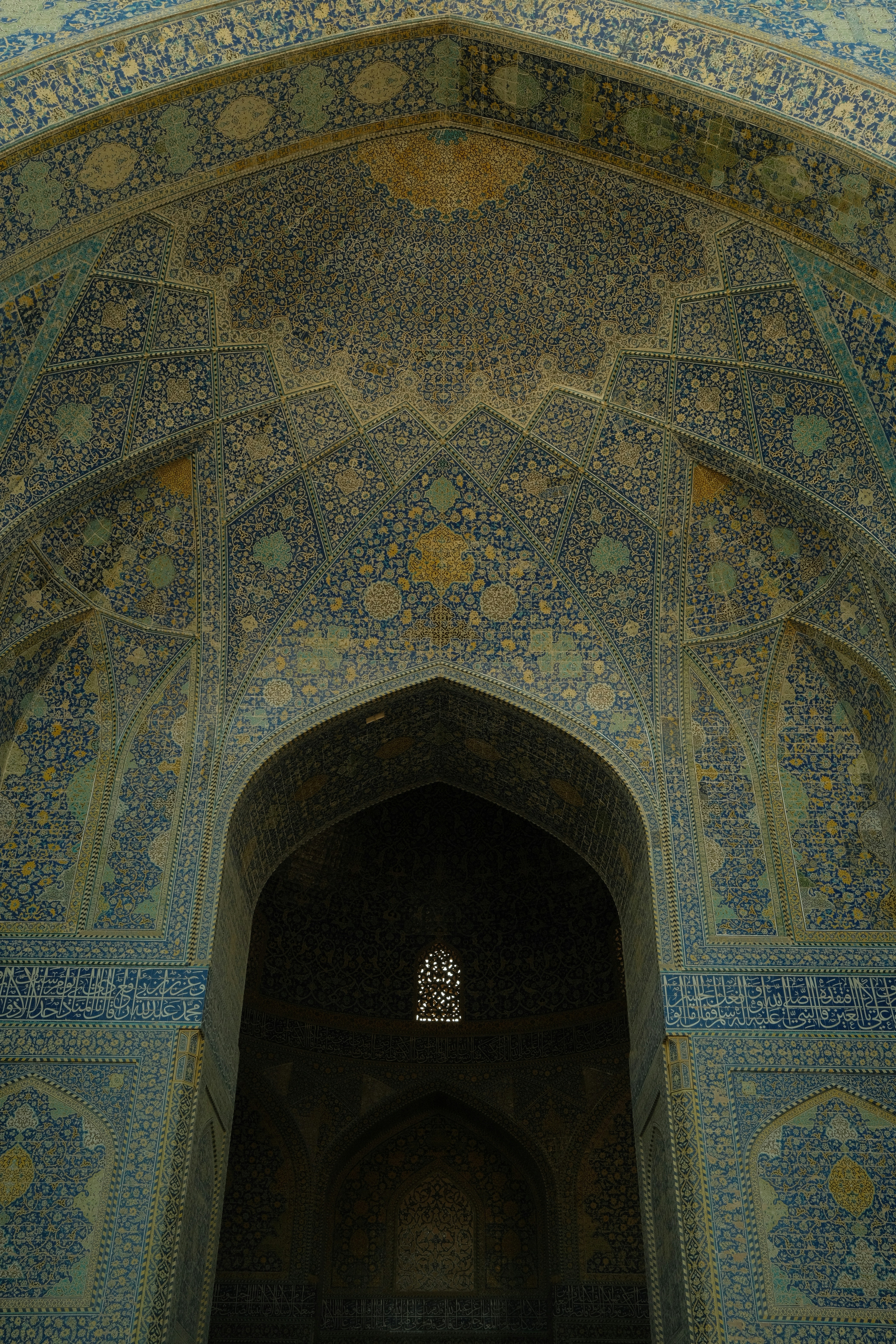 Intricate blue and white tilework adorns an arched entryway.