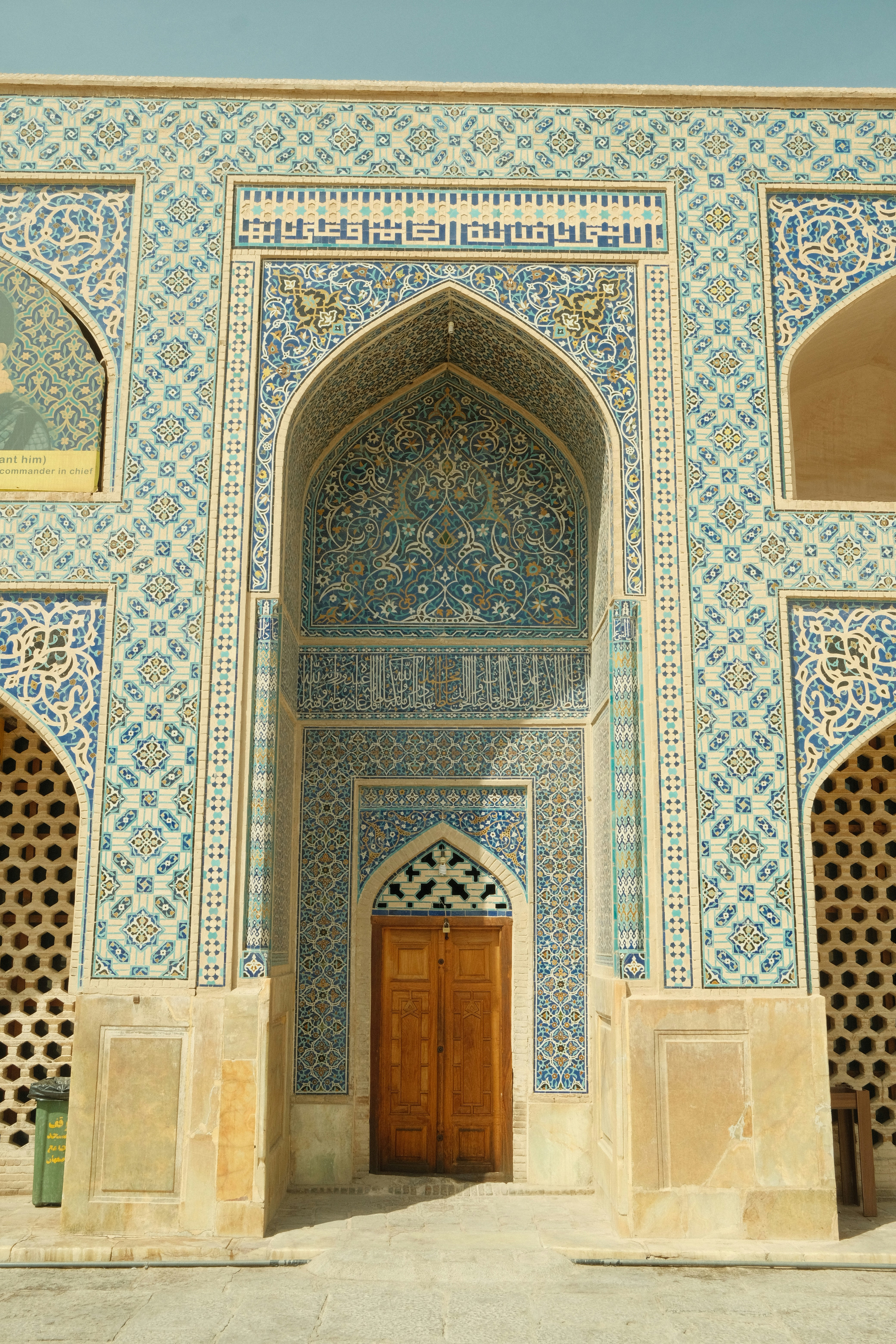 Ornate blue tilework adorns an arched doorway