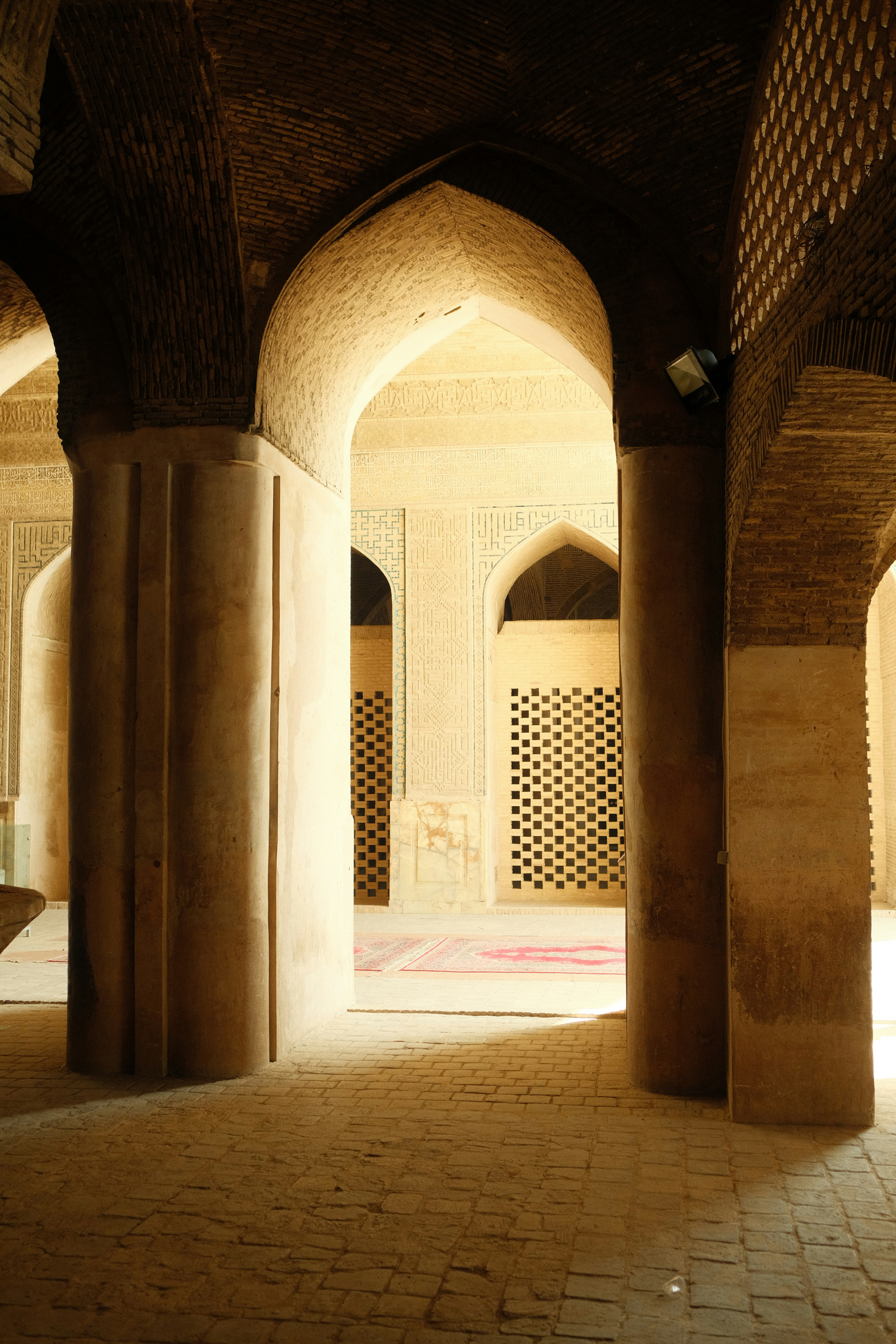 Arched passageway in an old building with patterned windows