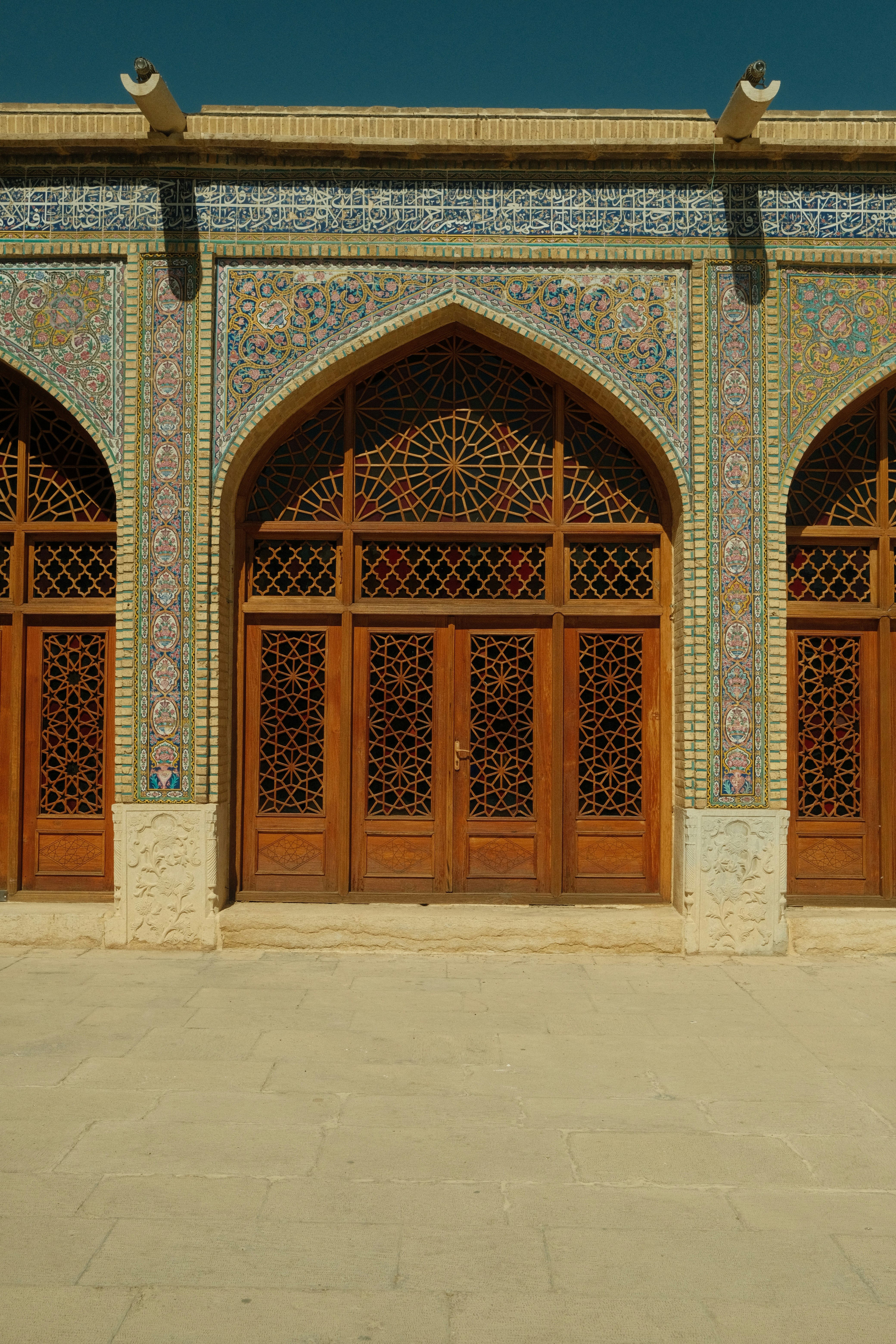 Ornate wooden doors with intricate tilework facade