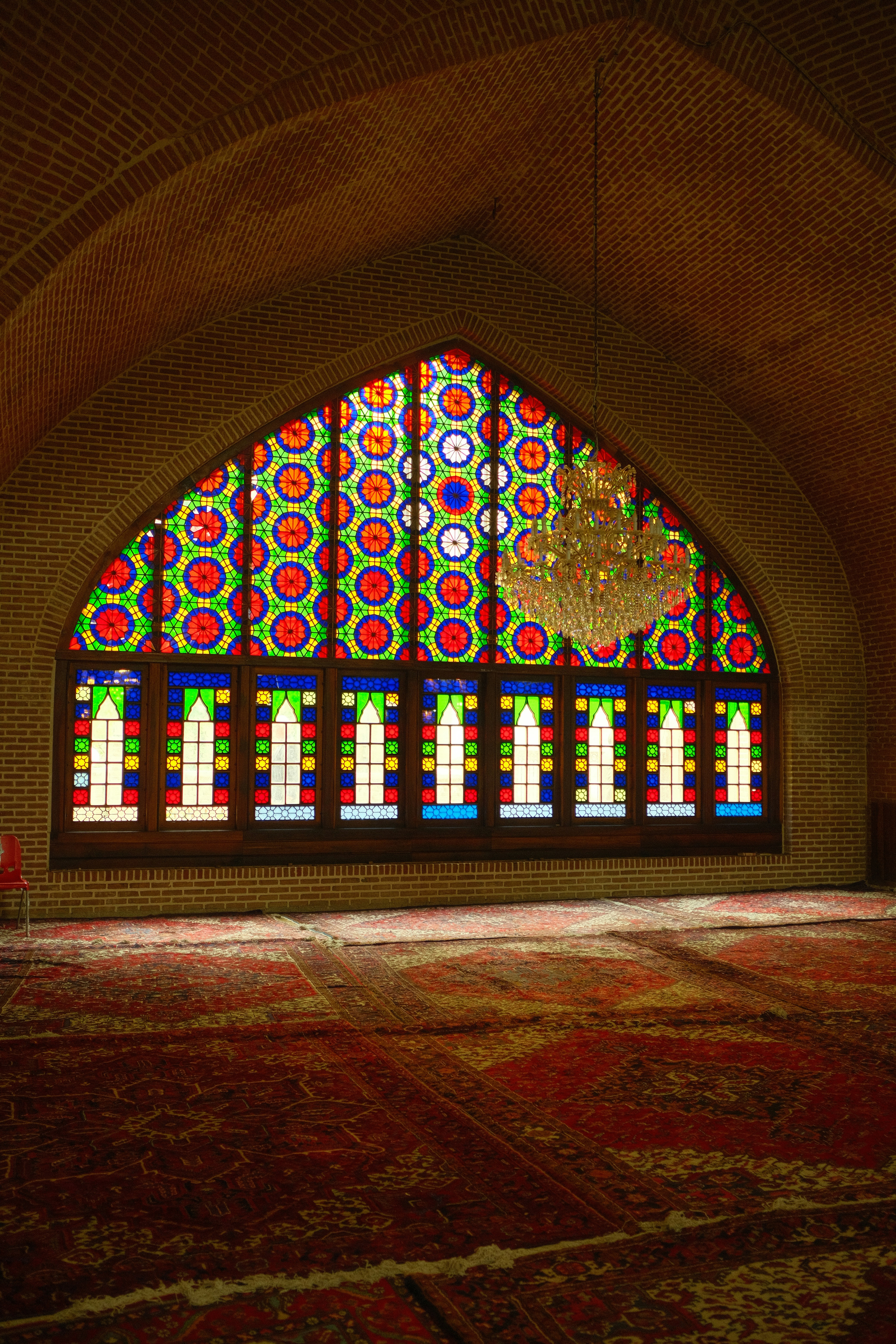 Colorful stained glass window in a mosque interior.