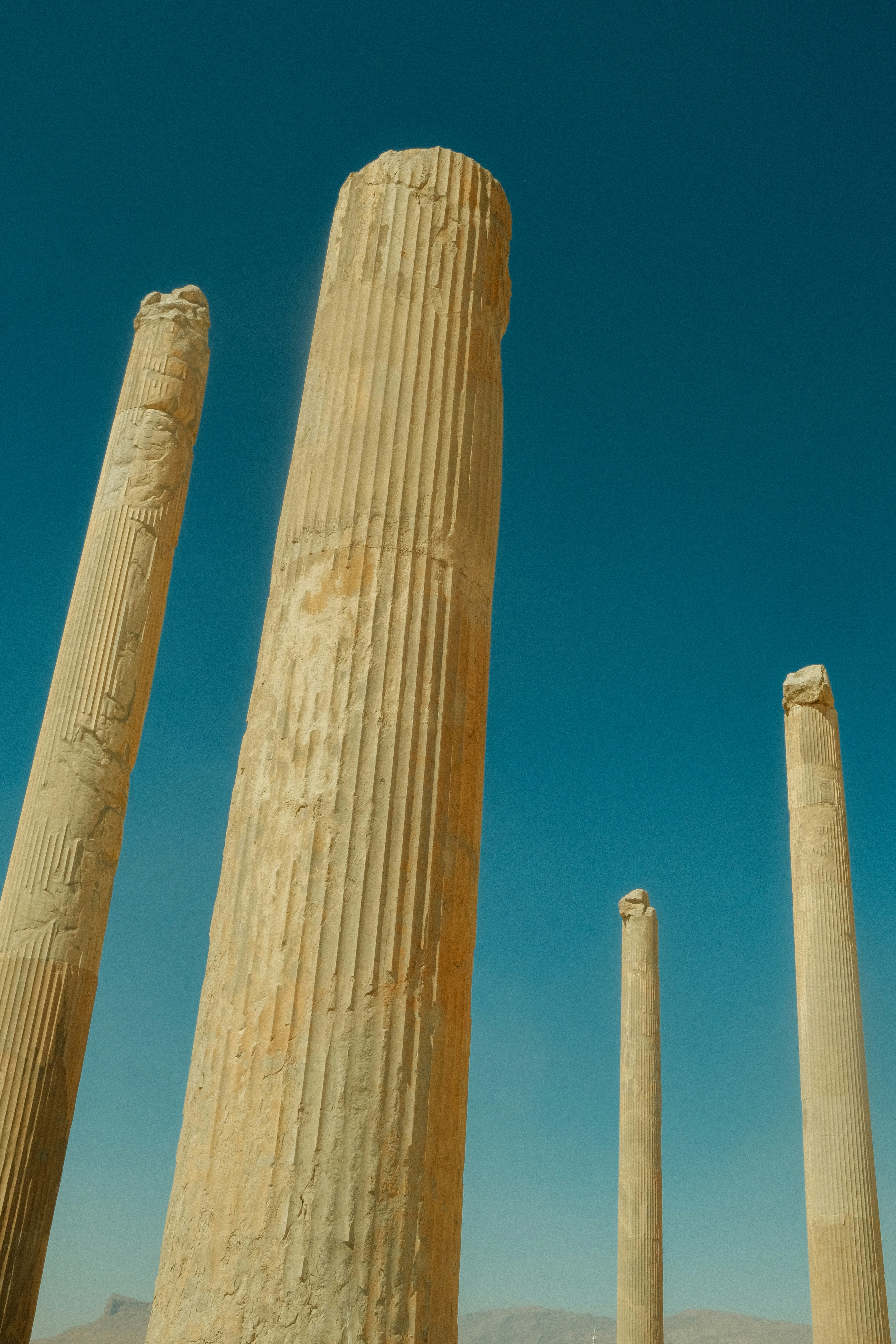 Ancient stone pillars against a clear blue sky