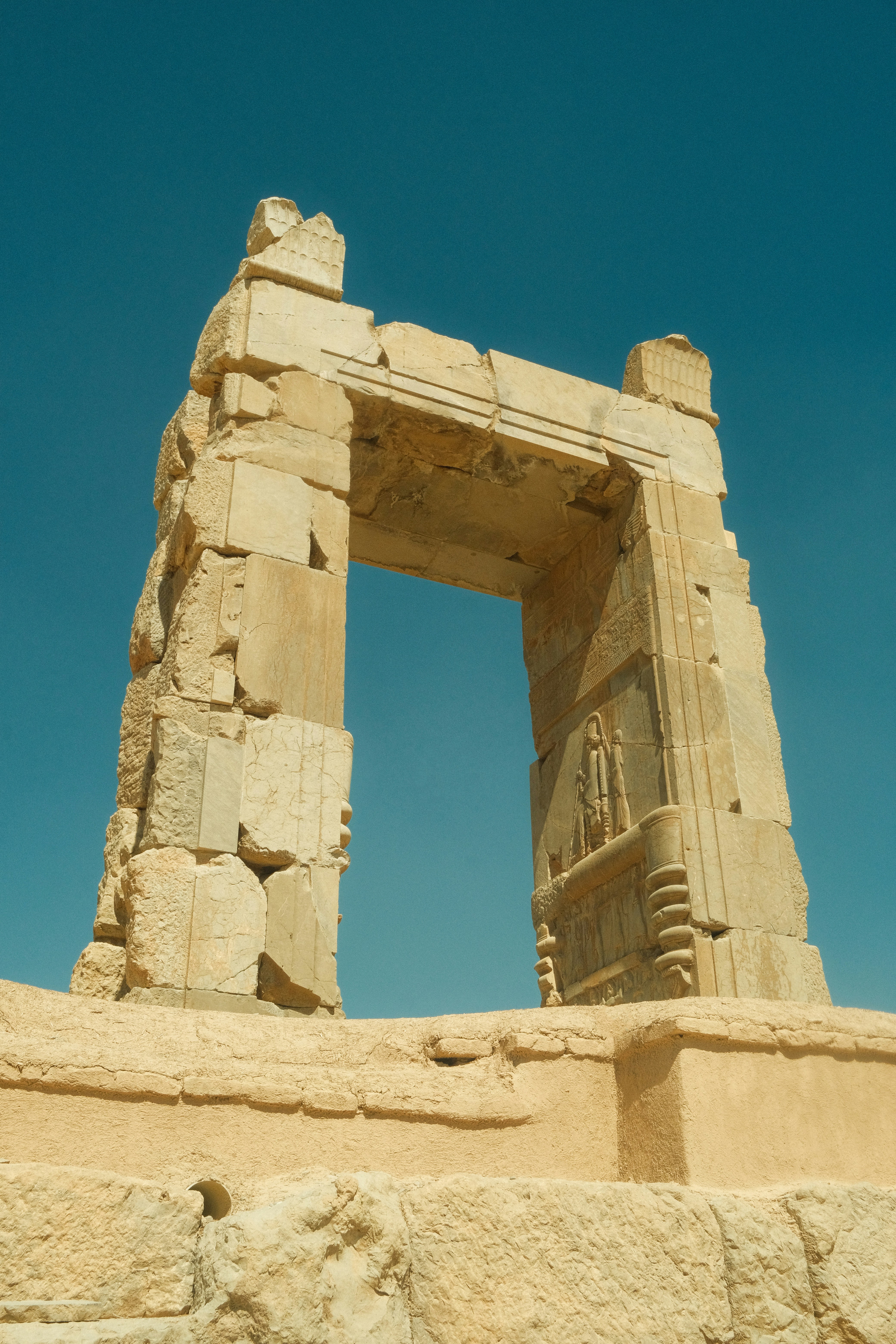 Ancient stone ruins against a clear blue sky.