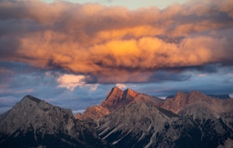 Majestic mountain peaks under a dramatic sunset sky