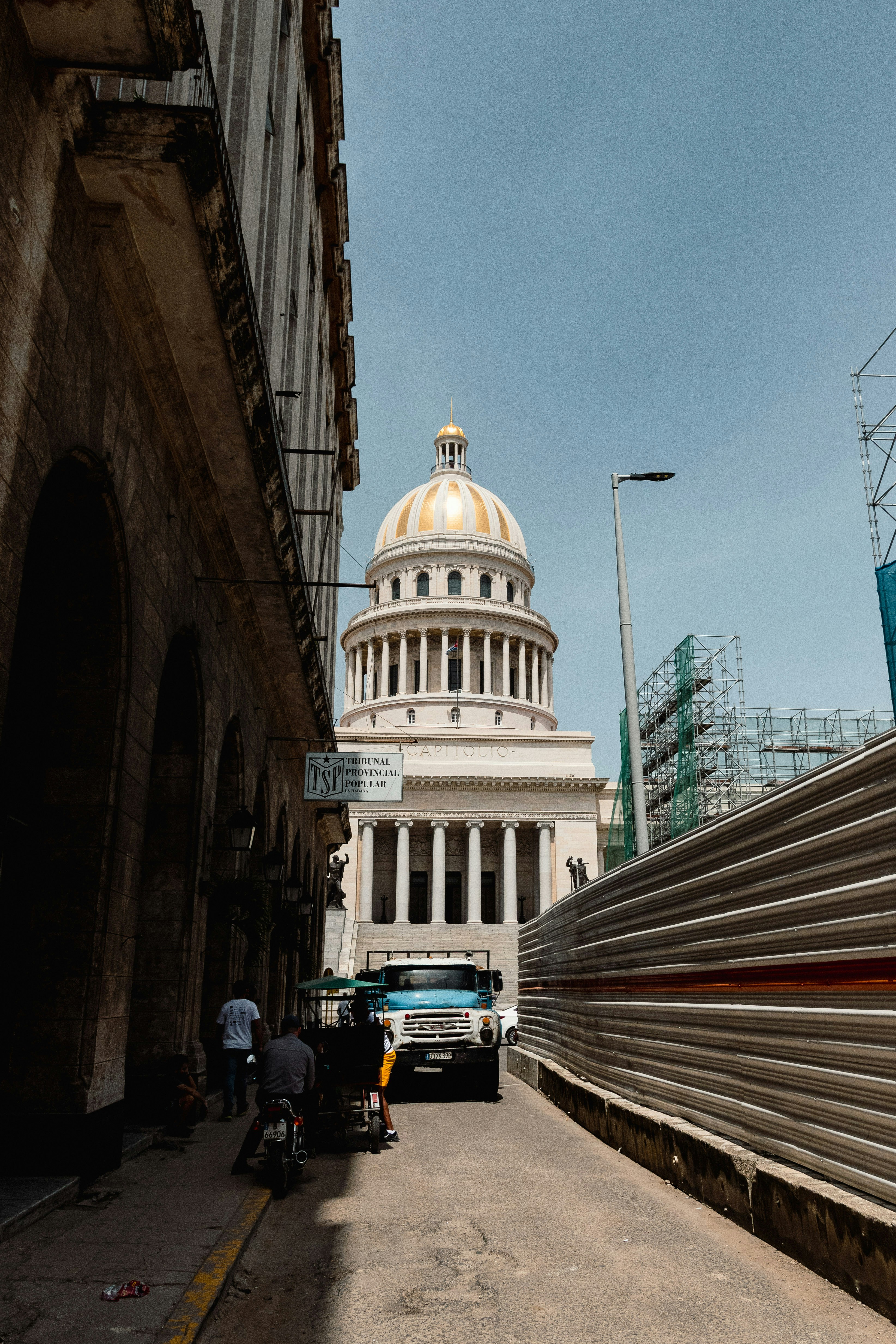 Grand building with a dome and a street scene.