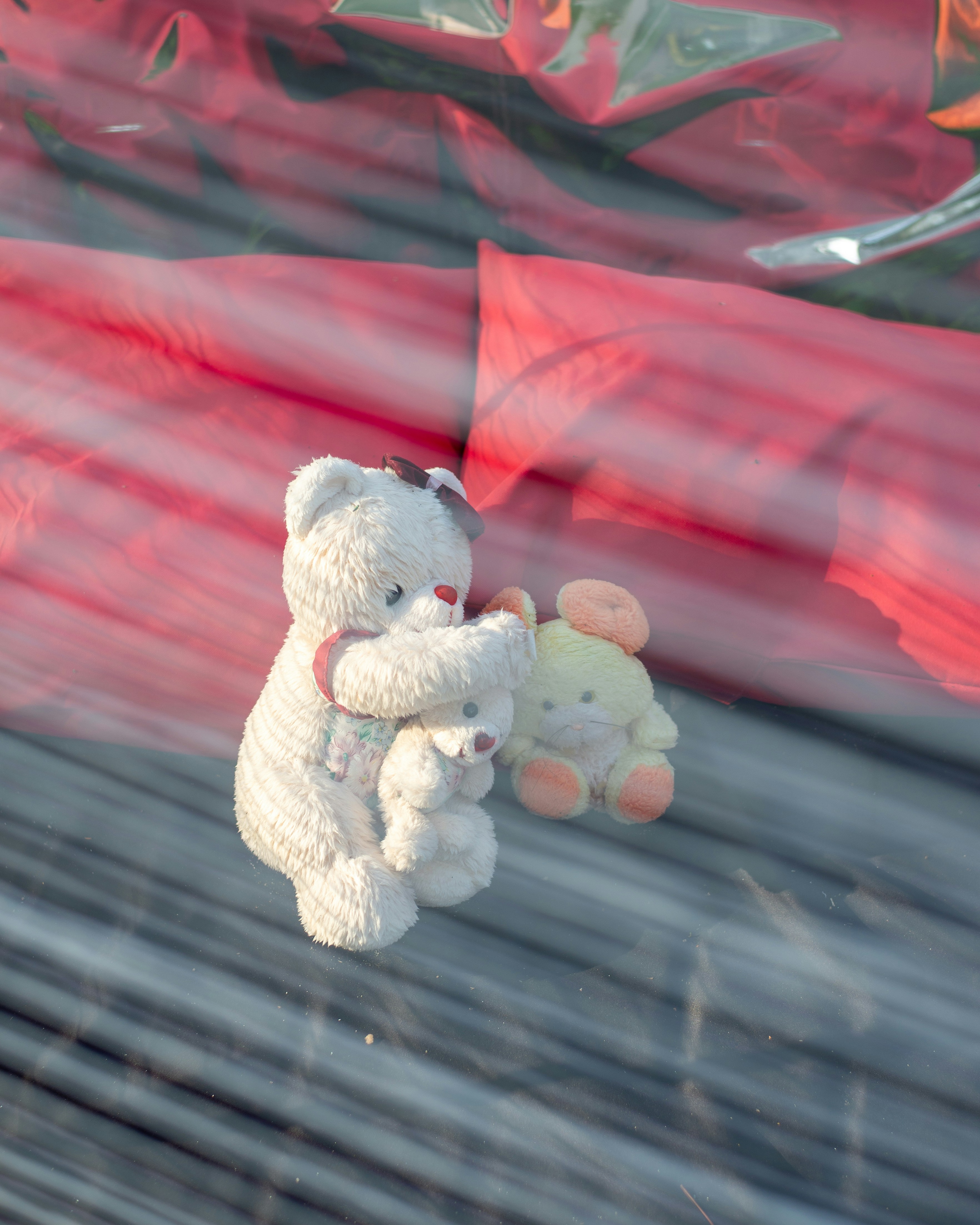 Three stuffed bears on a striped surface