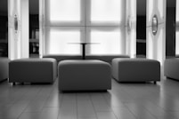 Modern lounge area with ottomans and a central table.