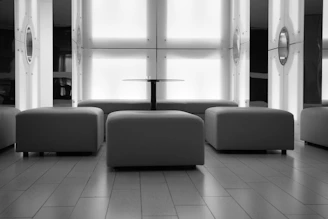 Modern lounge area with ottomans and a central table.