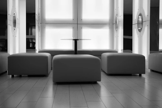 Modern lounge area with ottomans and a central table.