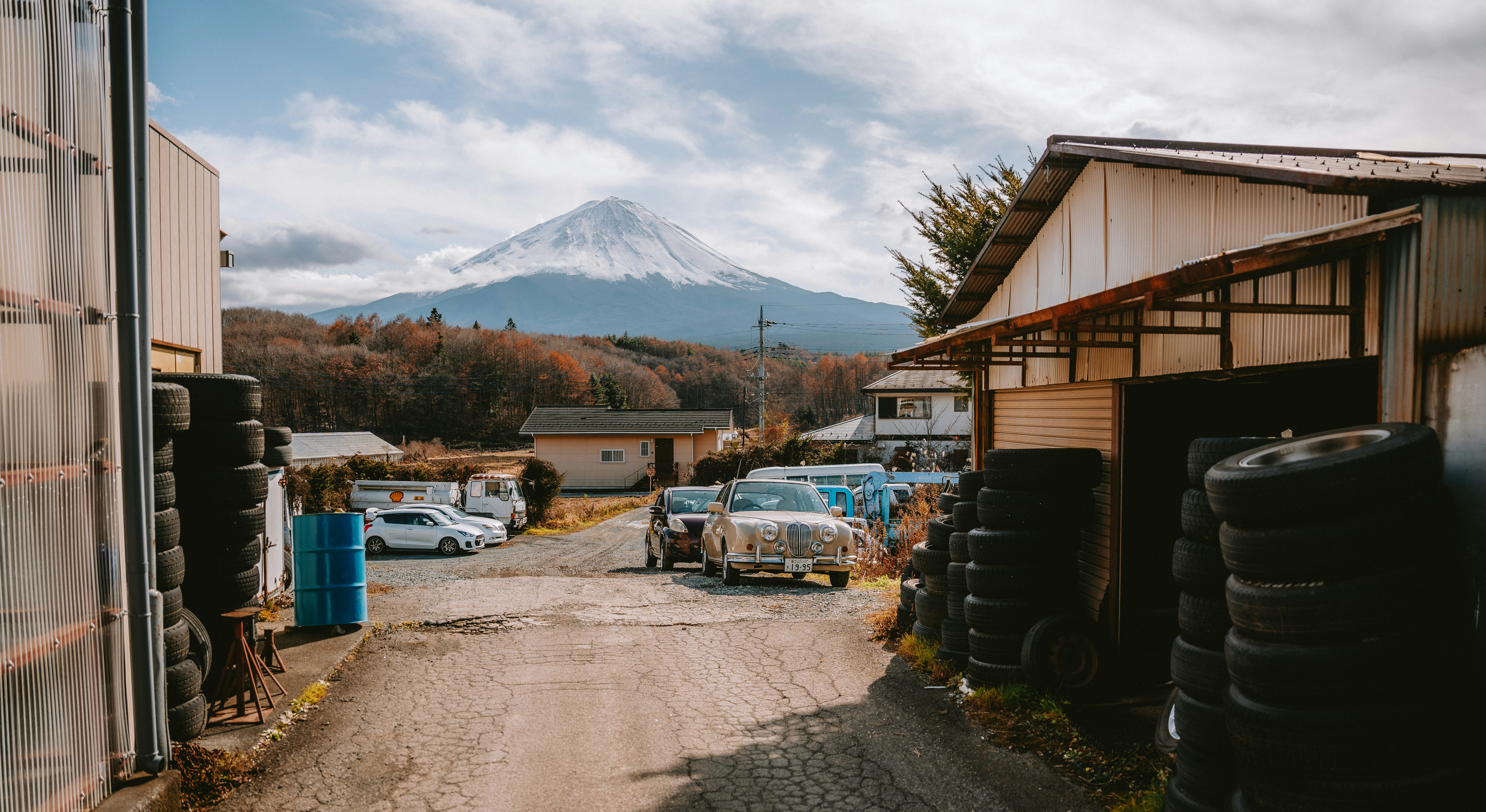 Mount fuji looms over a rural industrial area.