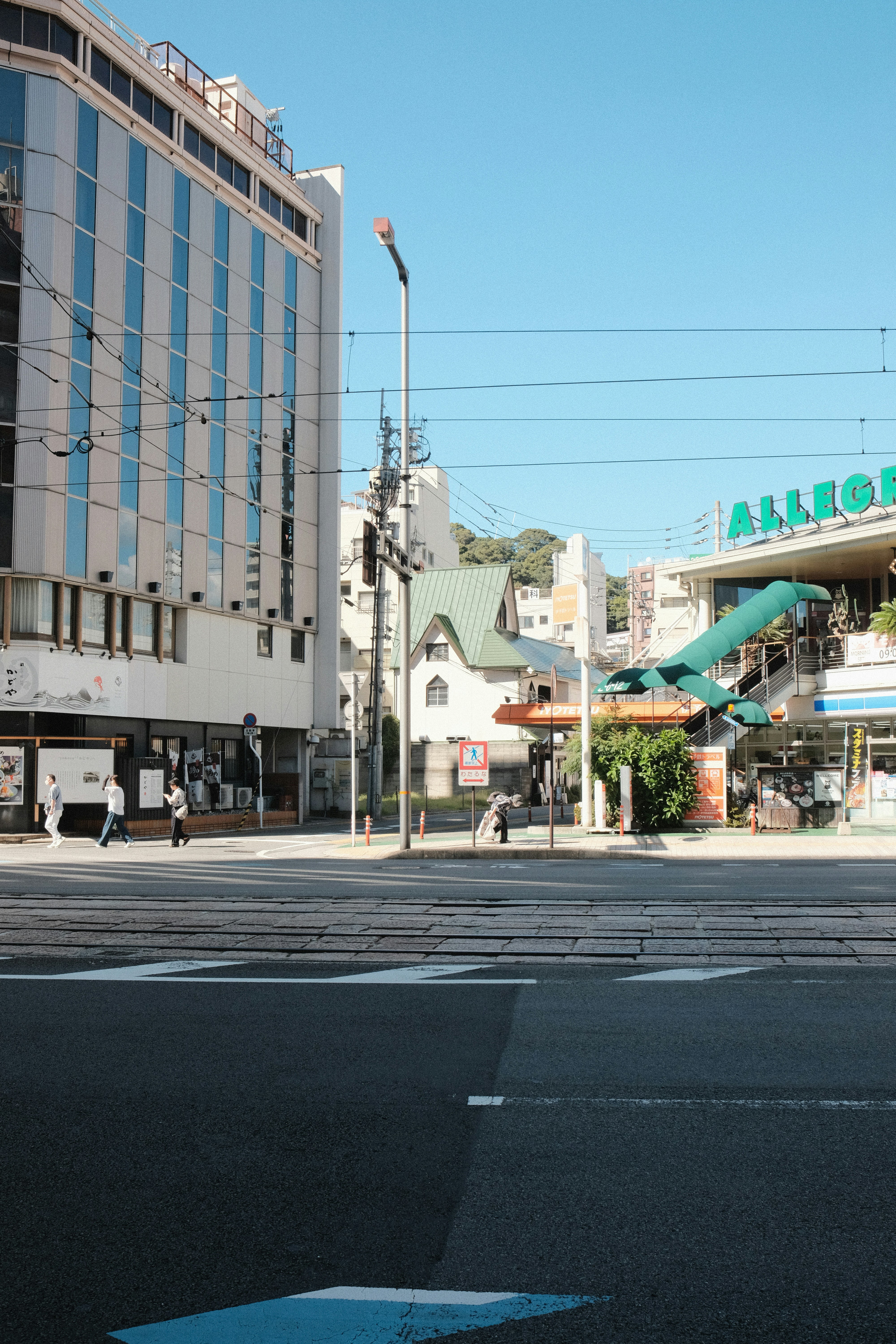City street with buildings and pedestrian crossing.