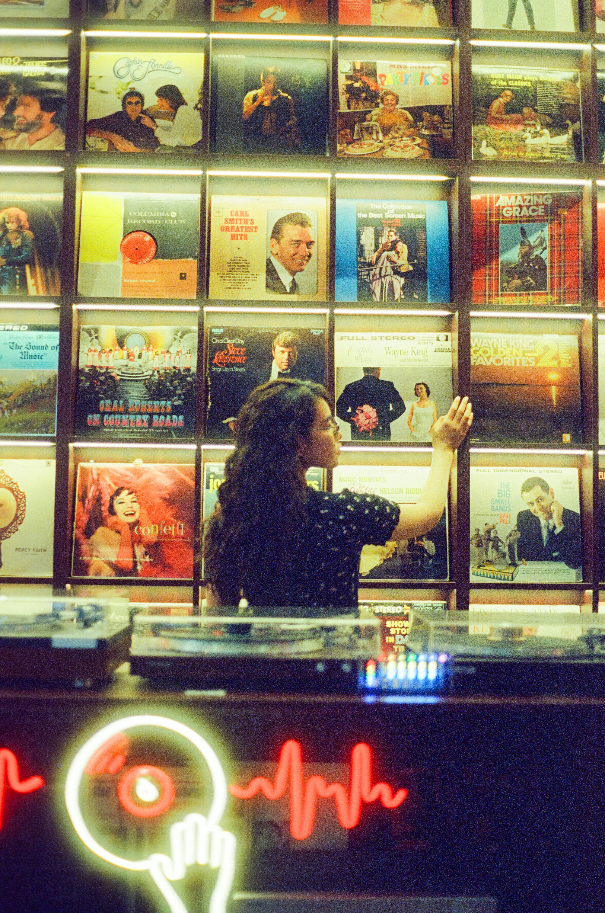 Woman browsing records in a music store