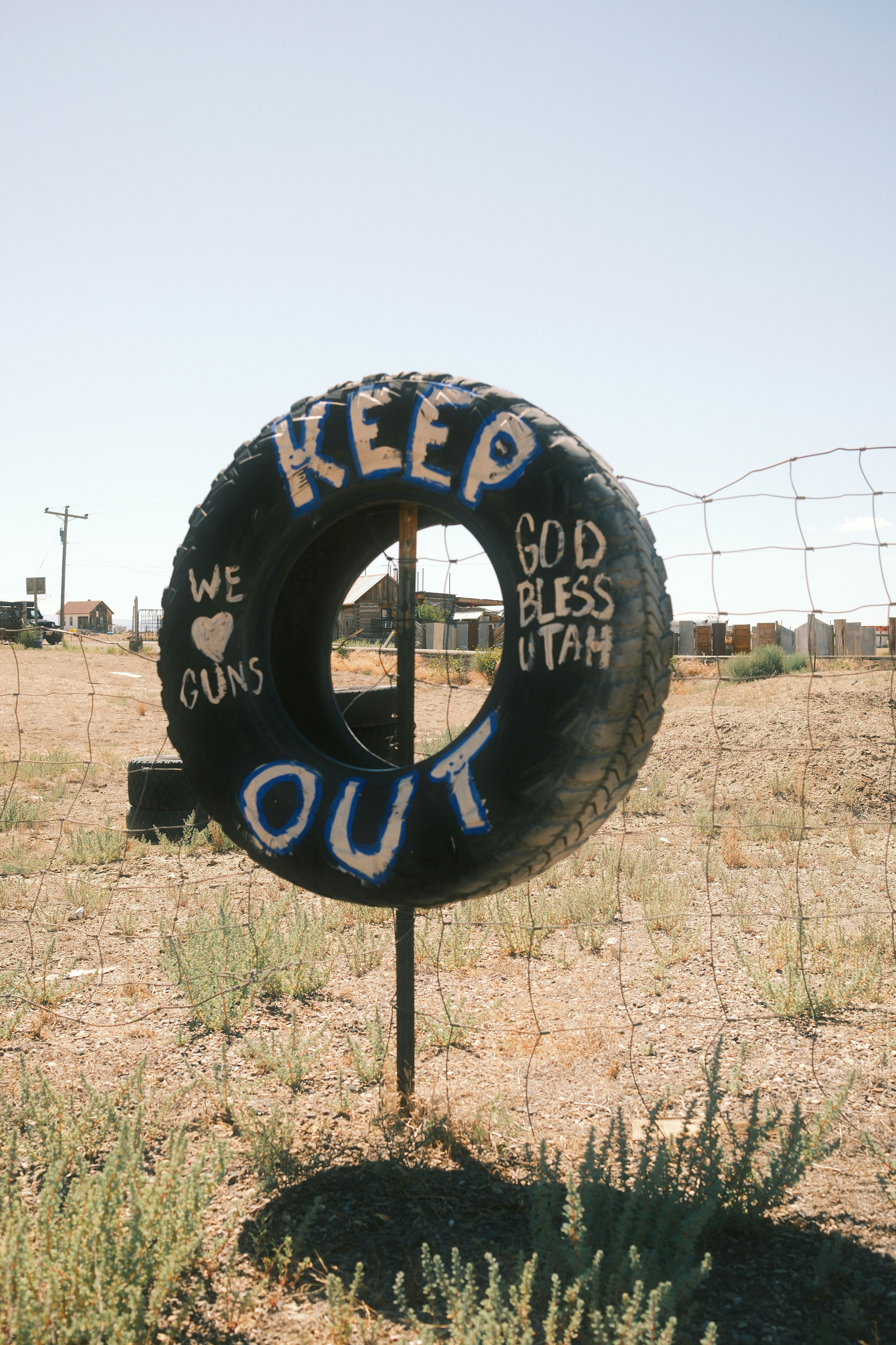 Tire with "keep out" and "god bless utah" painted.