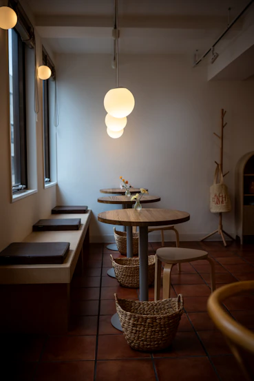 Cozy cafe interior with round tables and benches.