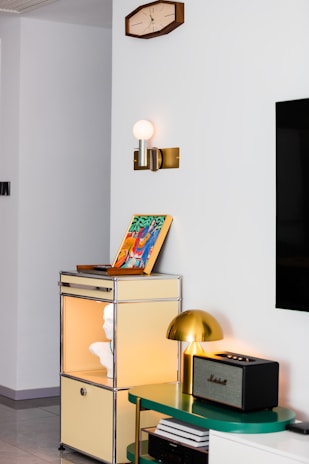 Modern living room corner with art and lamp.