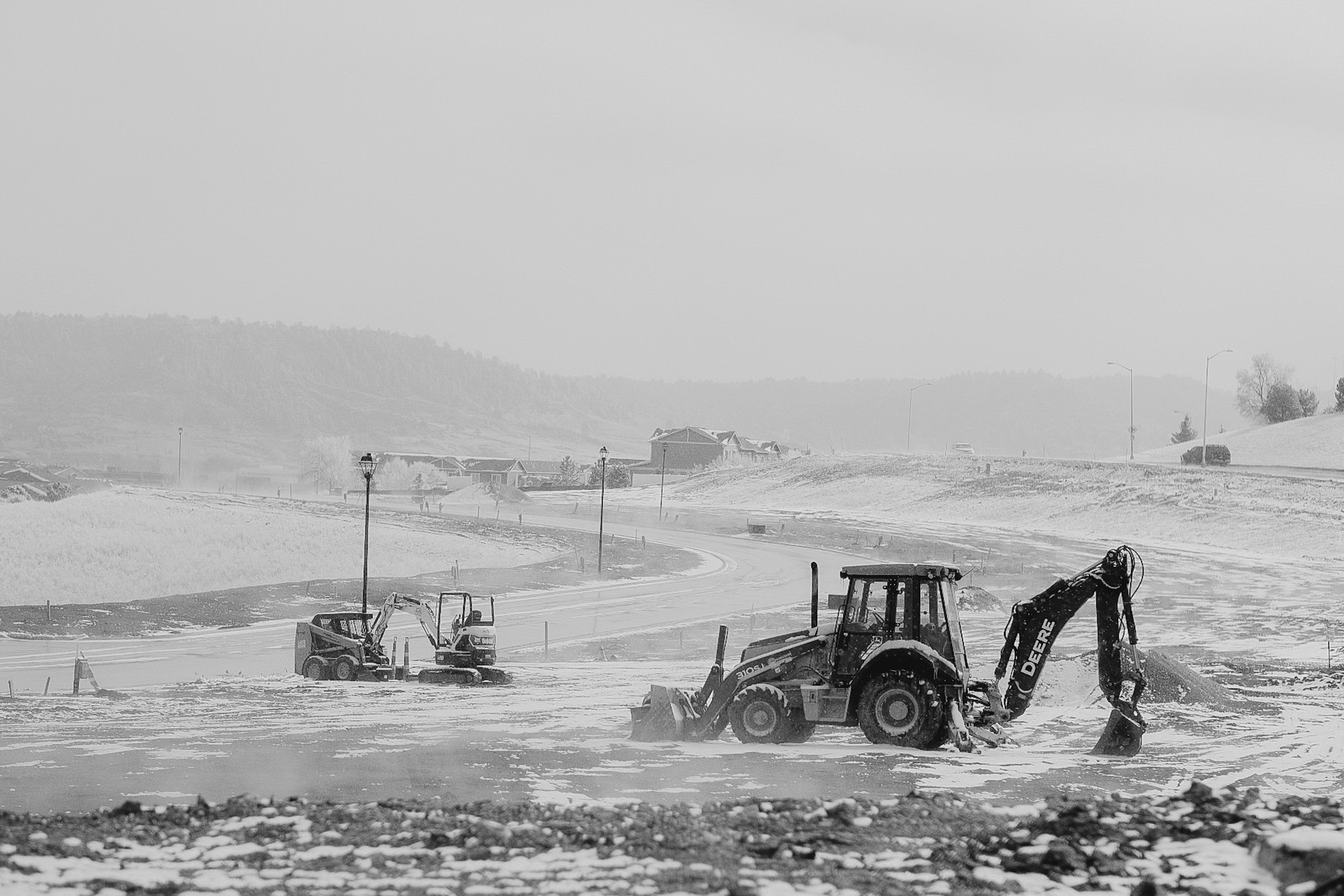 Construction site with excavators and loaders in winter