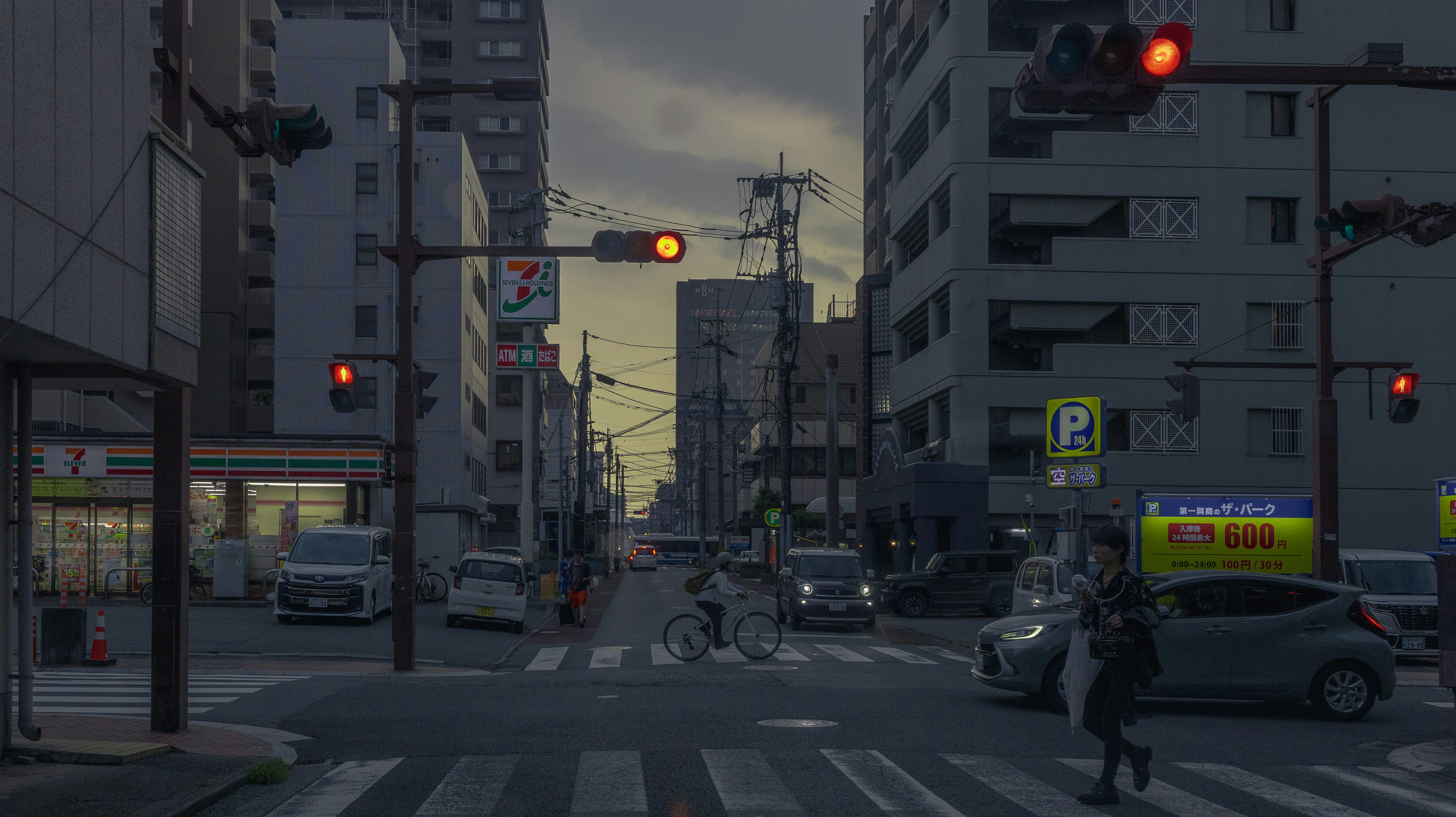 City street with traffic lights and buildings at dusk.