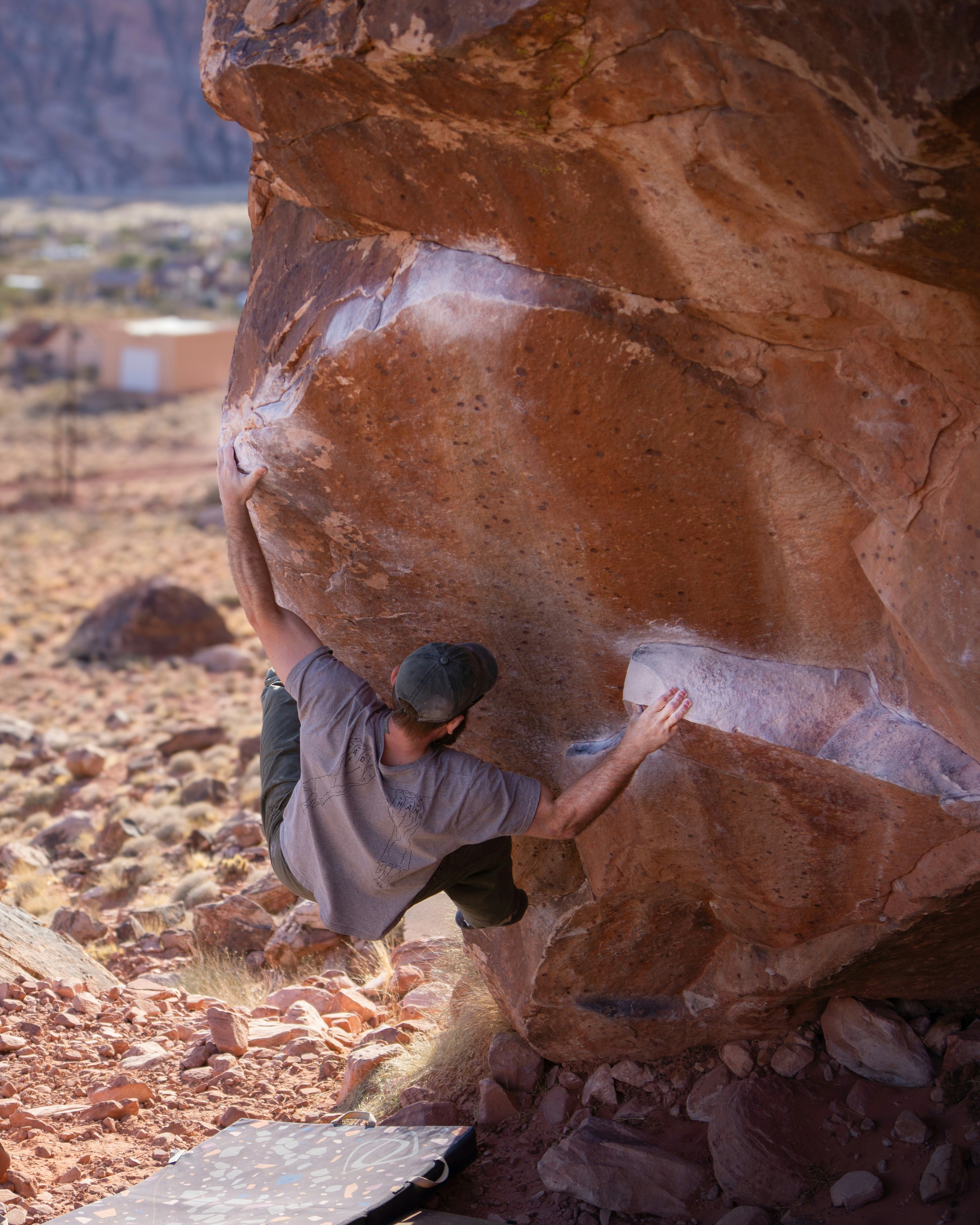 Man bouldering on a large rock outdoors