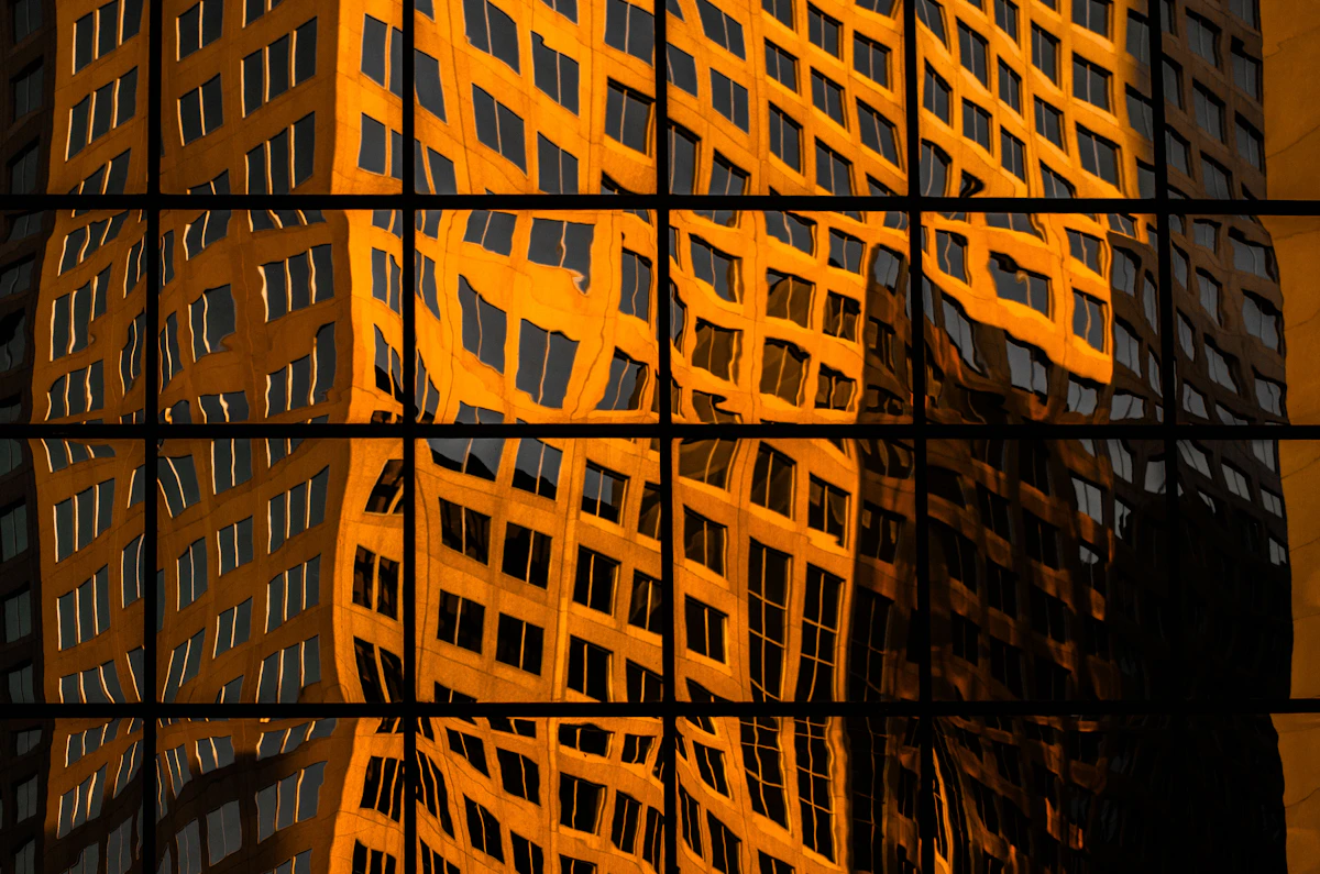 Golden reflection on a glass building facade, evoking strategic clarity