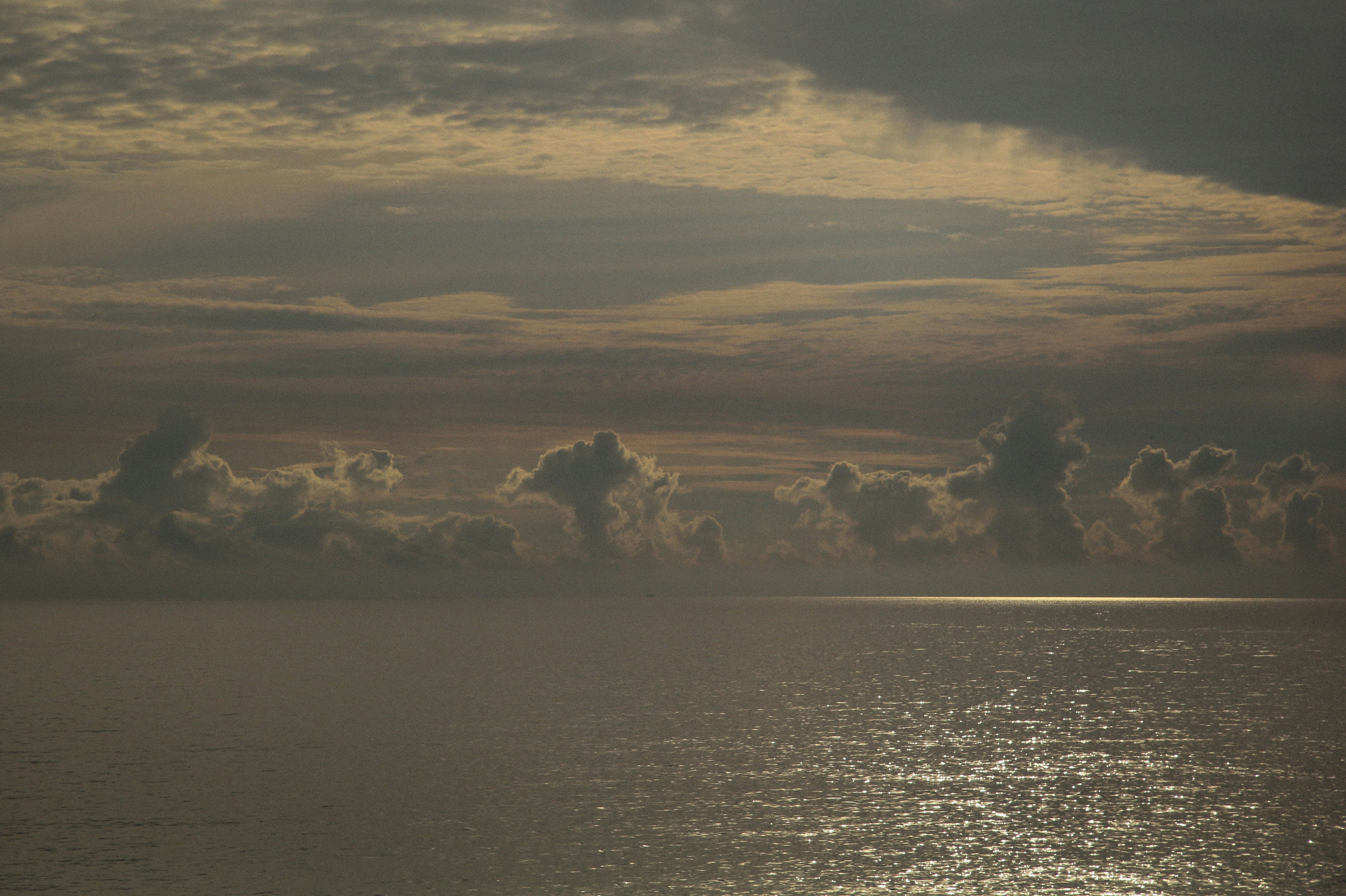 Ocean horizon with dramatic clouds at sunset