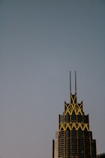Art deco skyscraper illuminated against twilight sky