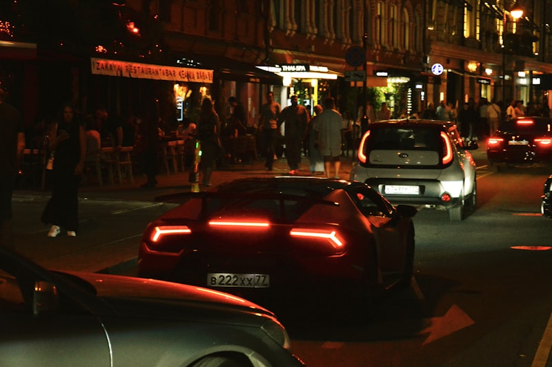 Luxury sports car driving on a city street at night
