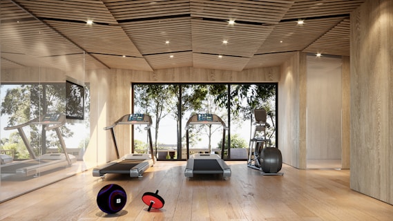 Modern gym with treadmills and large windows.