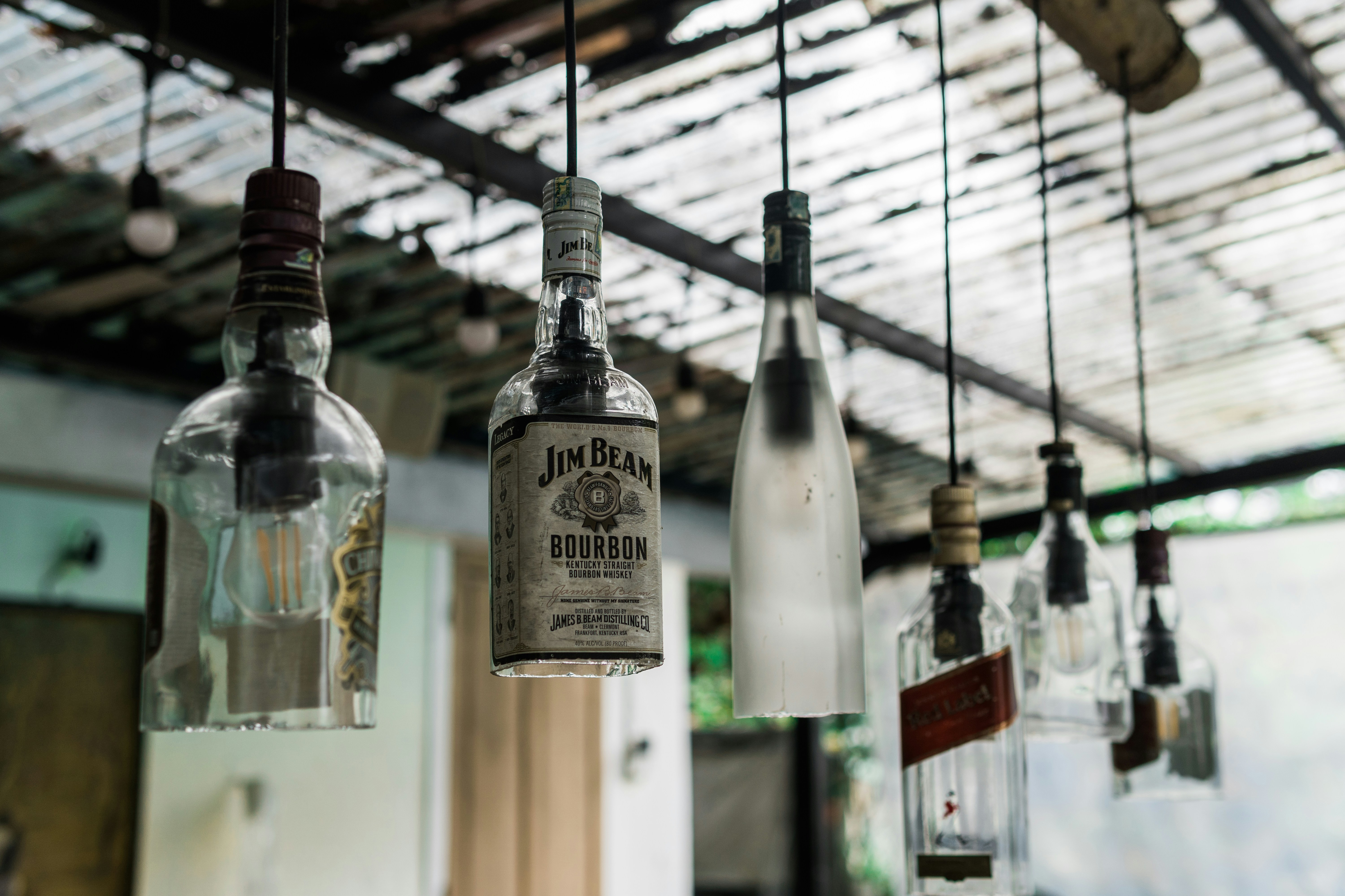Recycled glass bottles used as hanging light fixtures