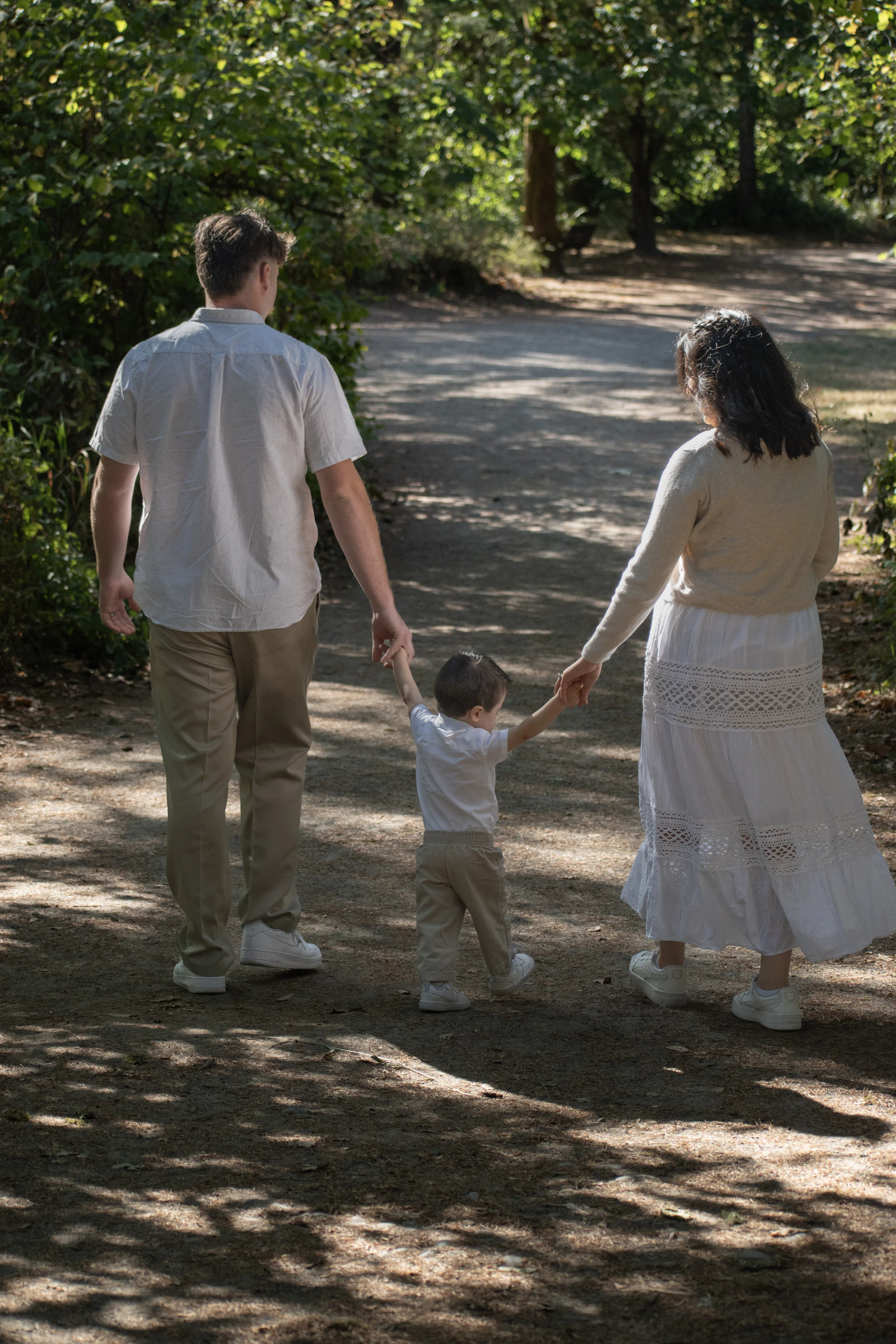 Family walking on a path through the woods
